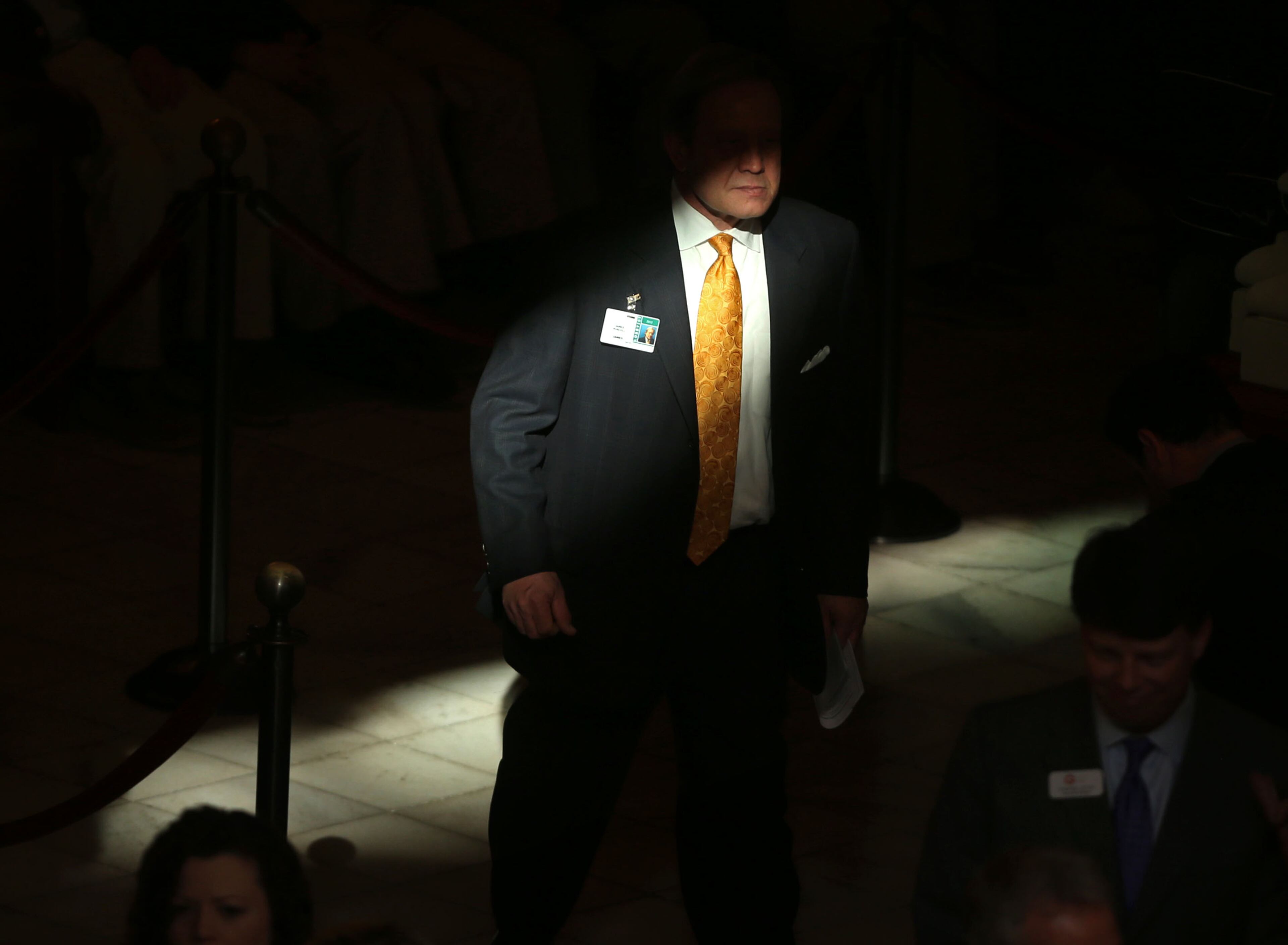 The sun spotlights a lobbyist as he walks through a hallway near the House Chambers during Legislative Day 40 at the Capitol Thursday night in Atlanta, Ga., March 28, 2013. Thursday is the last day of the 2013 Legislative Session.