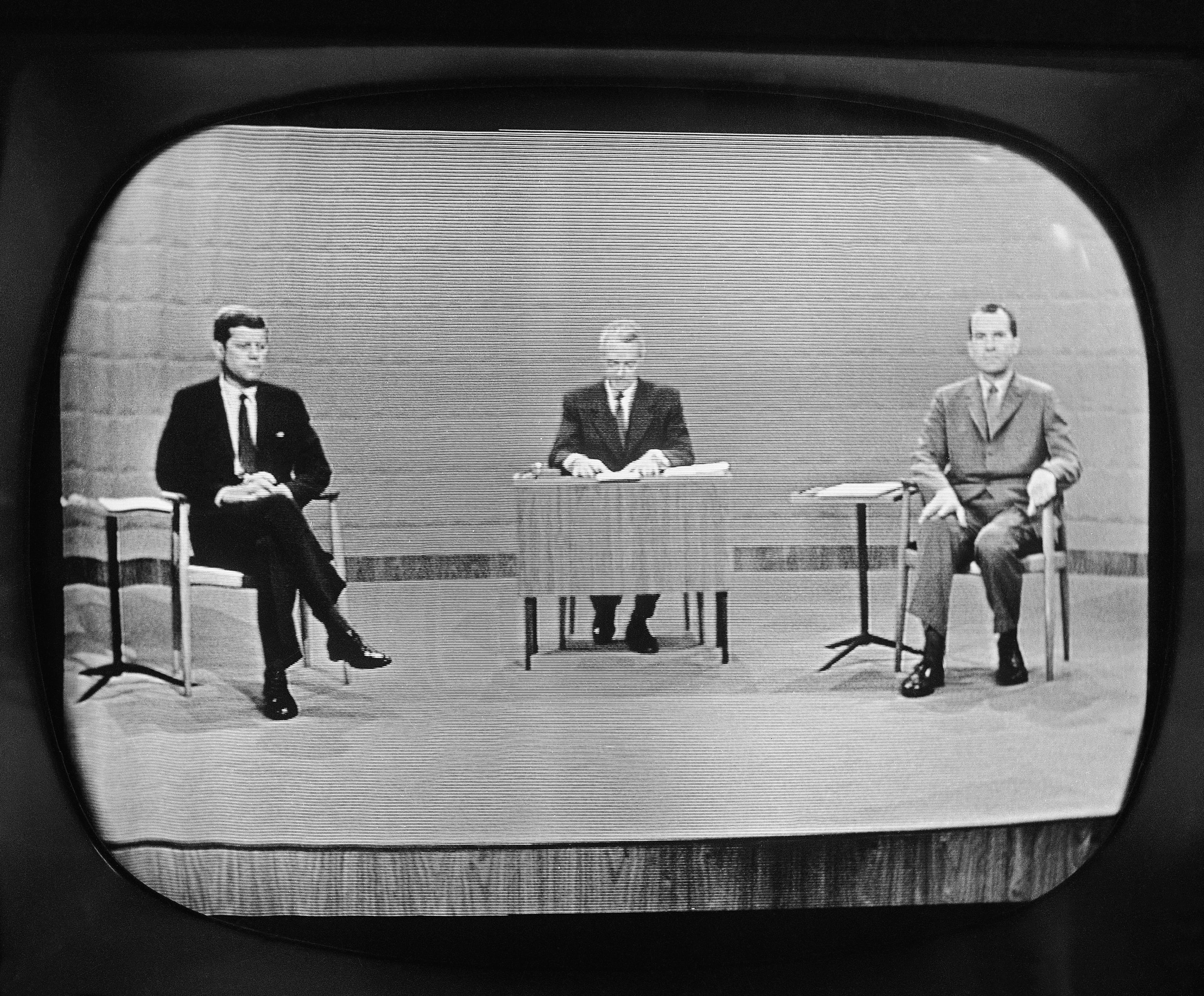 Moderator Howard K. Smith sits between Sen. John Kennedy, left, and Vice President Richard Nixon as they appear on television studio monitor set during their debate in Chicago. The Kennedy image, the "mystique" that attracts tourists and historians alike, did not begin with his presidency and is in no danger of ending 50 years after his death. The multimedia story began in childhood with newsreels and newspaper coverage of the smiling Kennedy brood, and it continued with books, photographs, movies and finally television, notably the telegenic JFK's presidential debates with Nixon. (AP file photo)