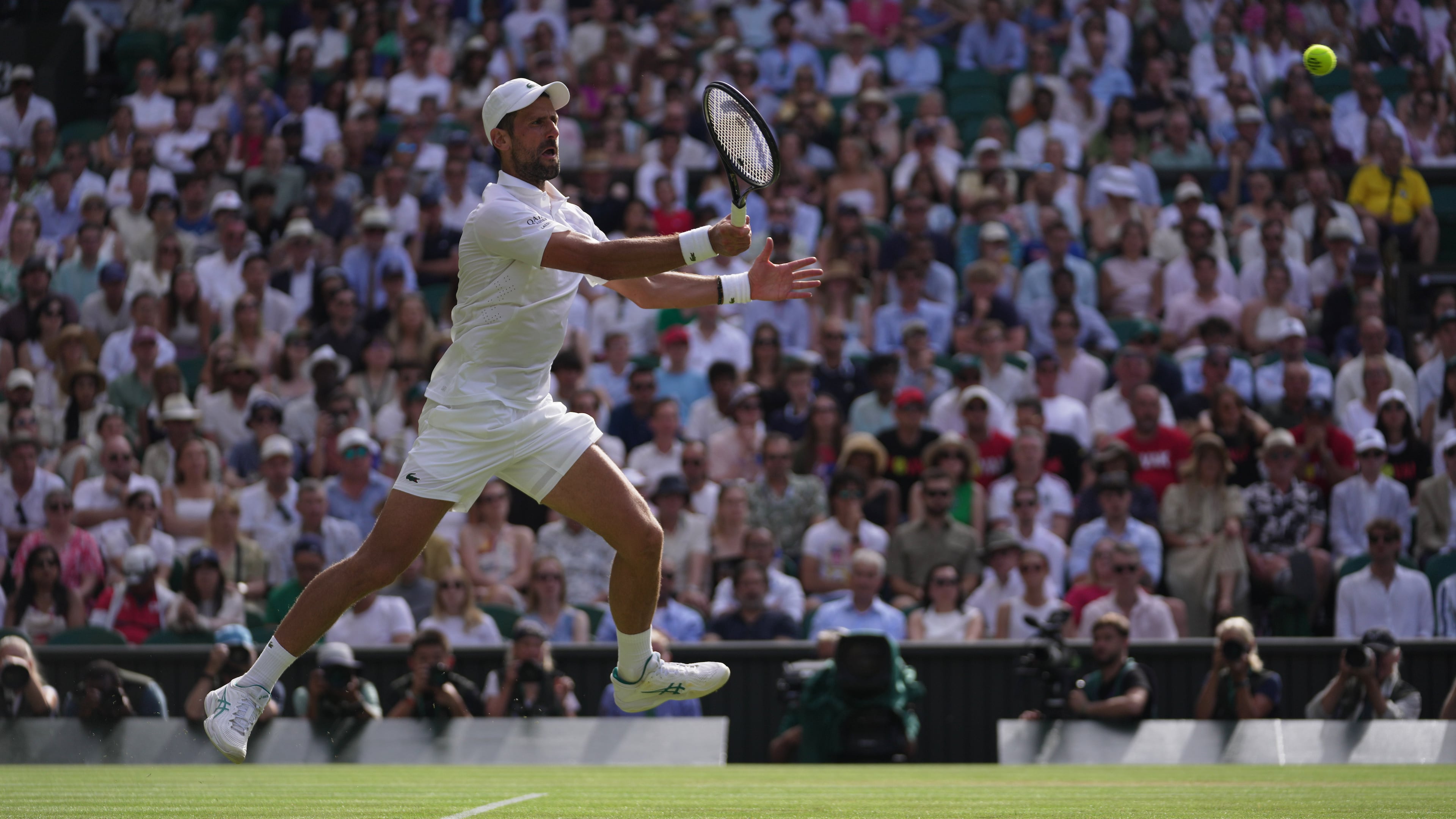 Novak Djokovic of Serbia returns the ball to Roman Saffiulin of Russia in their fourth round men's singles match at the Wimbledon Tennis Championships in London, Sunday, July 5, 2026. (AP Photo/Brian Inganga)