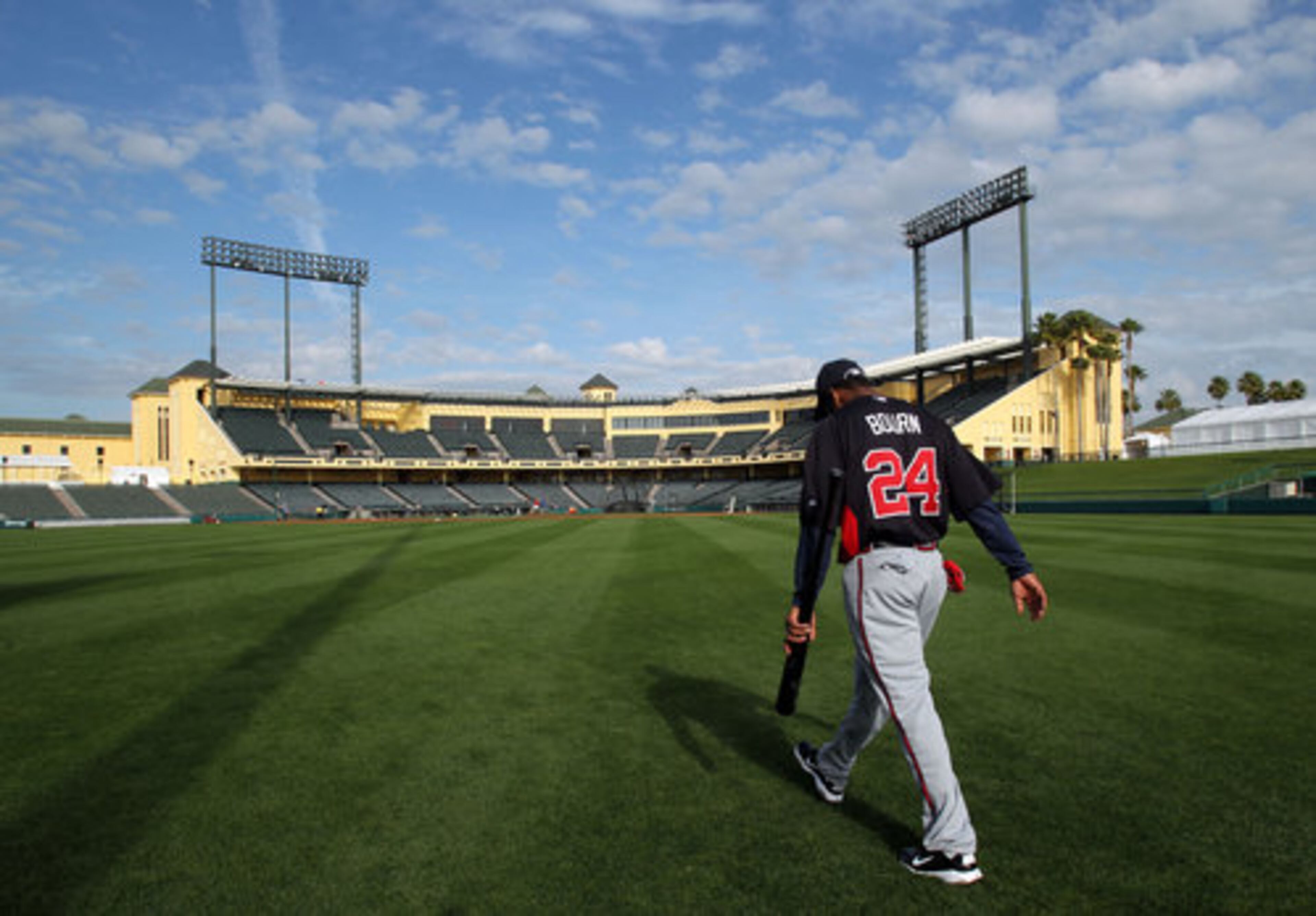 Michael Bourn walks through Champion Stadium's outfield. Since Bourn was acquired through a trade with the Astros last season, this is his first spring training in a Braves uniform.