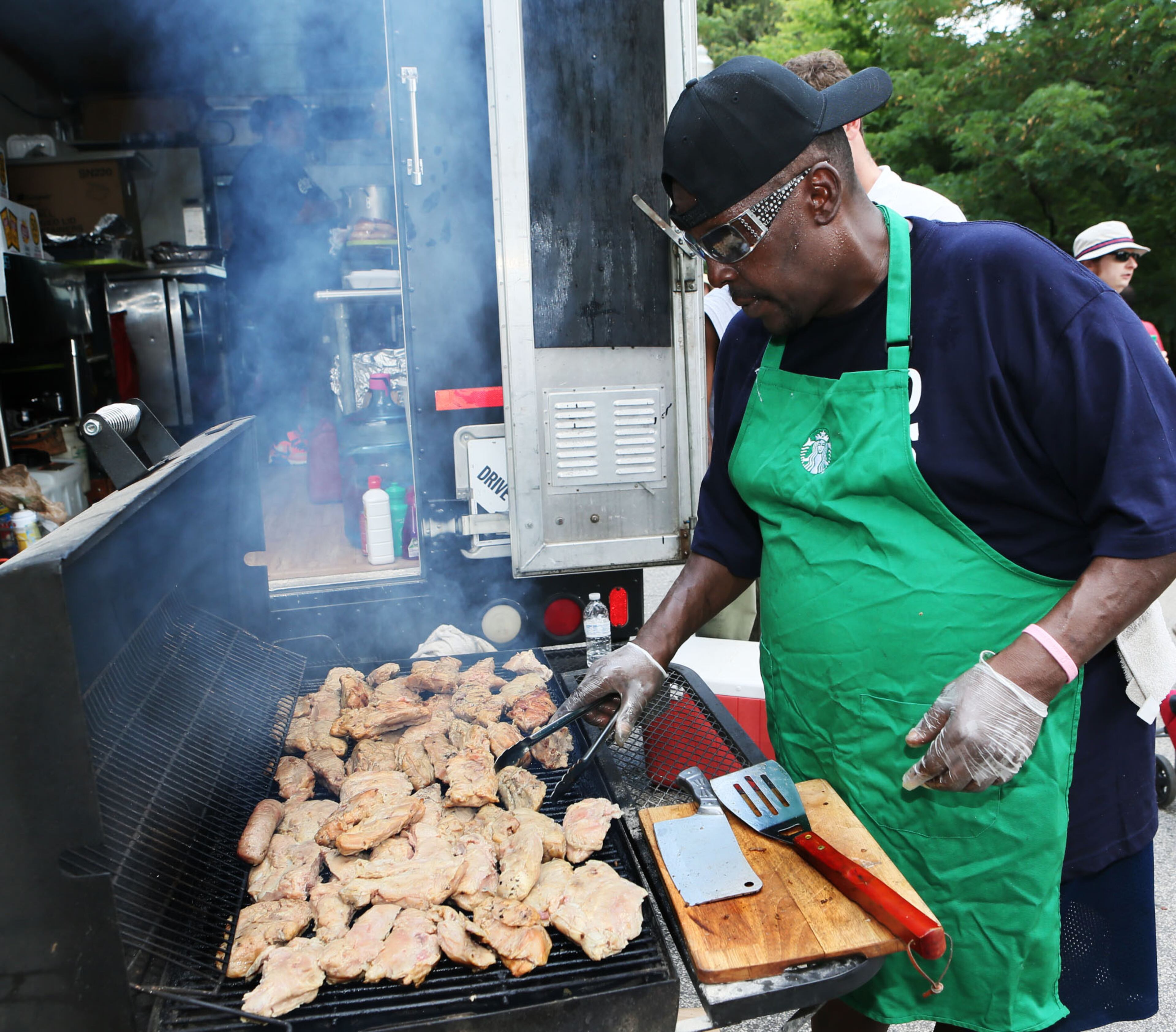 Norris Copeland cooked up turkey ribs. More than 40 food trucks lined the park's walkway offering a wide variety of cuisine. (Photo by Phil Skinner)