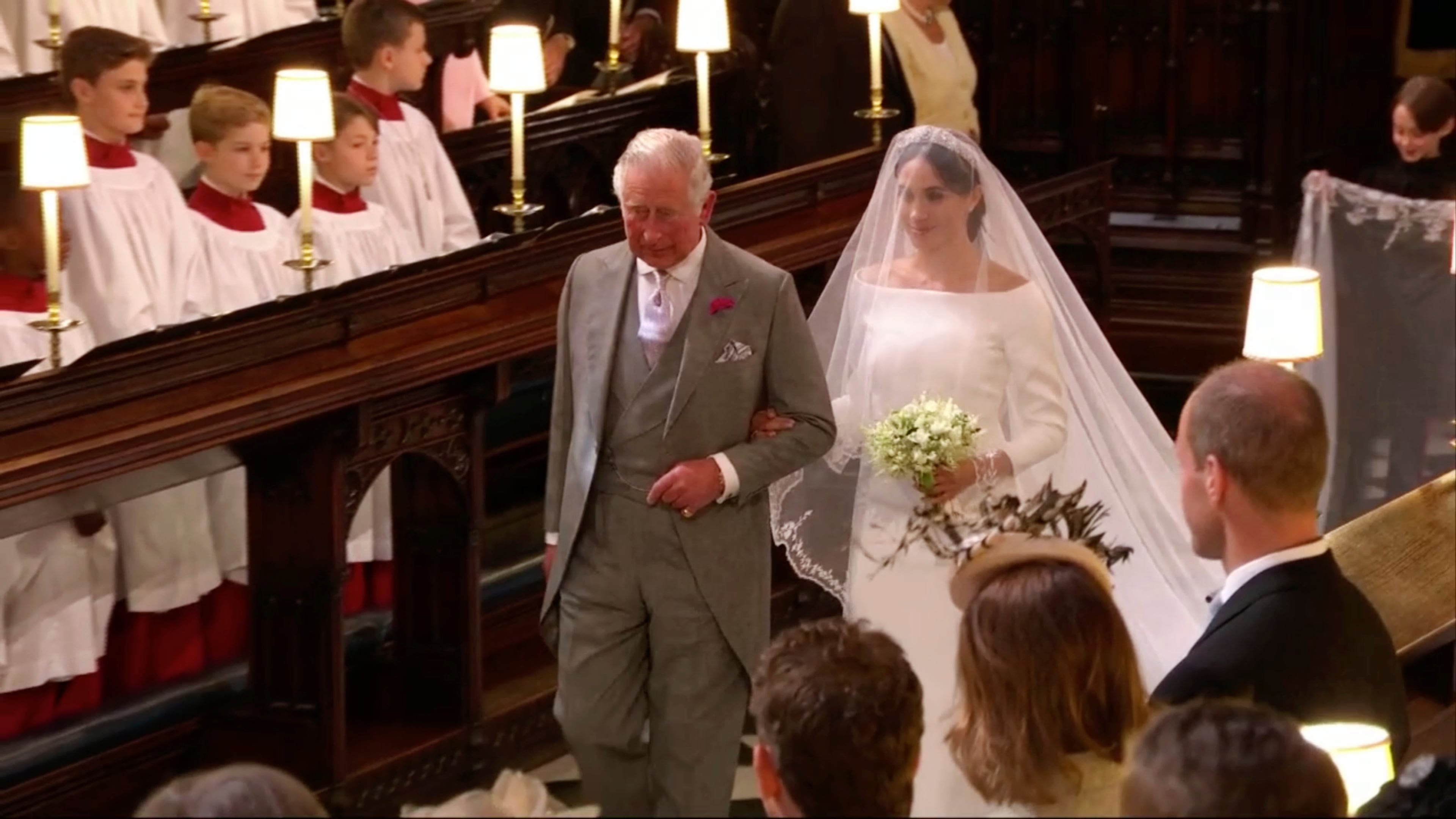 In this frame from video, Meghan Markle walks down the aisle with Prince Charles for her wedding ceremony at St. George's Chapel in Windsor Castle in Windsor, near London, England, Saturday, May 19, 2018. (UK Pool/Sky News via AP)
