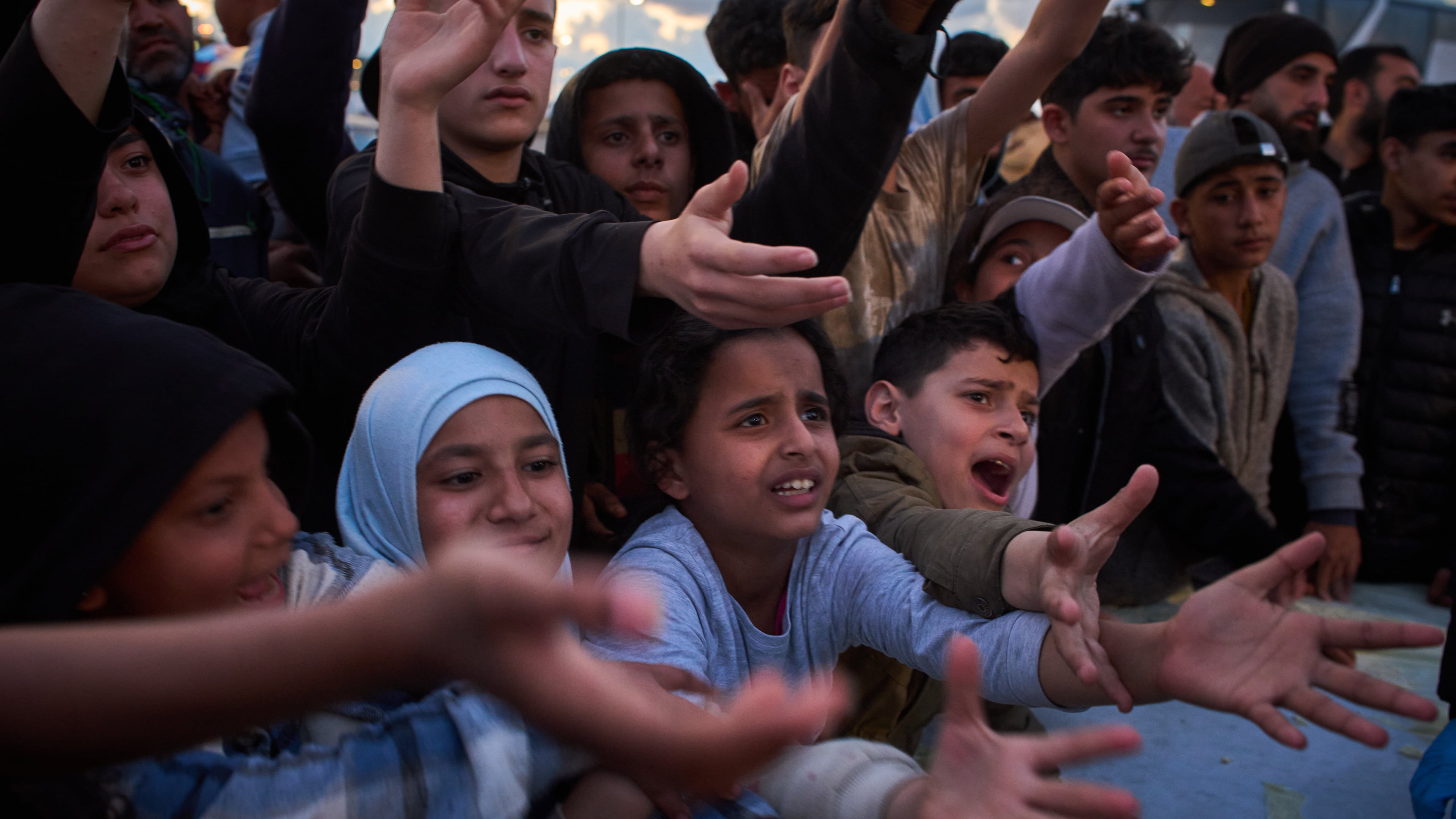 Displaced people wait to receive donated food beside the tents they use as shelters after fleeing Israeli bombardment in southern Lebanon, in Beirut, Lebanon, Monday, April 6, 2026. (AP Photo/Emilio Morenatti)