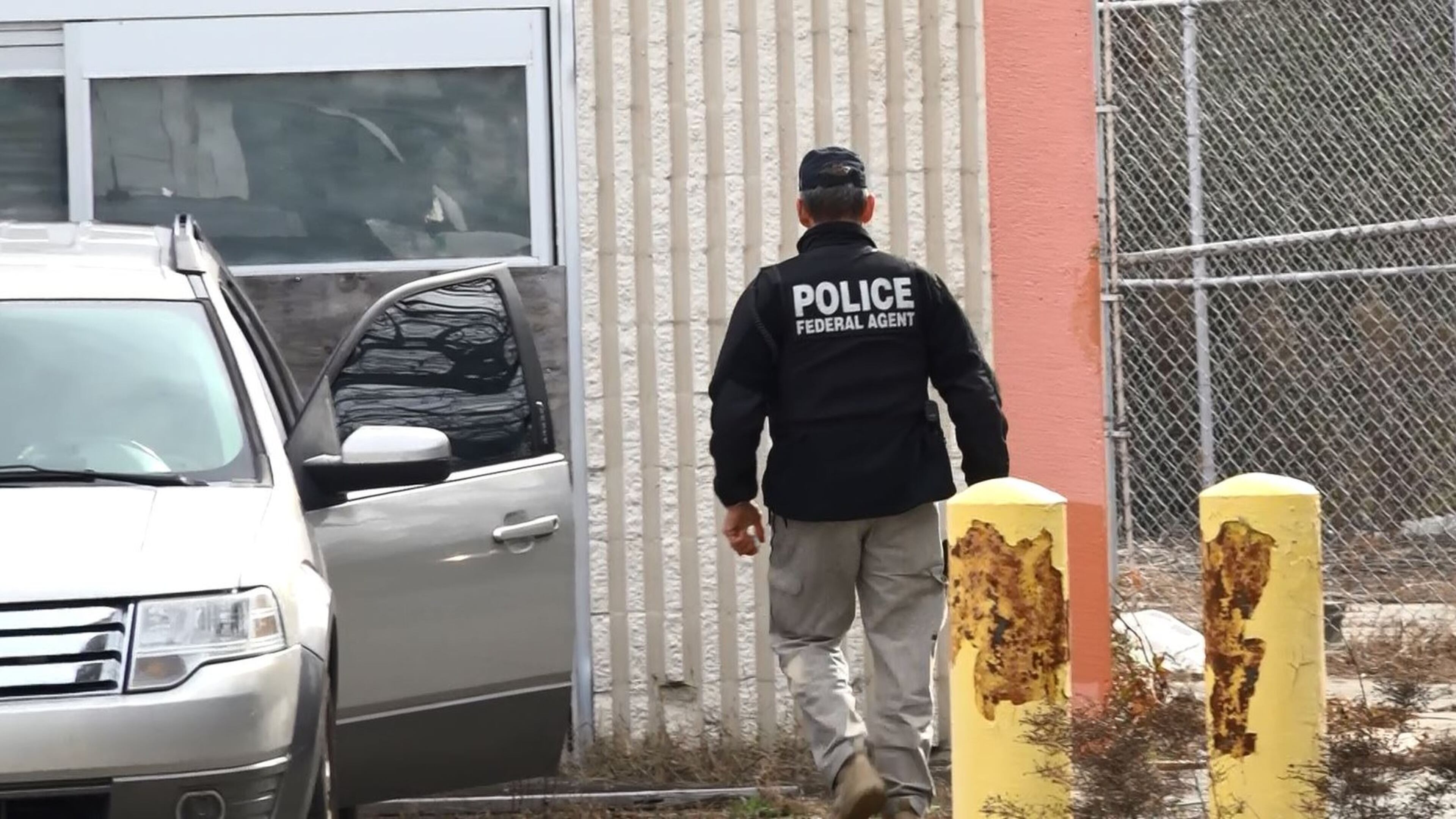 An officer from ICE returns to his vehicle during the raid Saturday in metro Atlanta. At least eight women and their children were detained during the operation. Mario Guevara/MundoHispanico