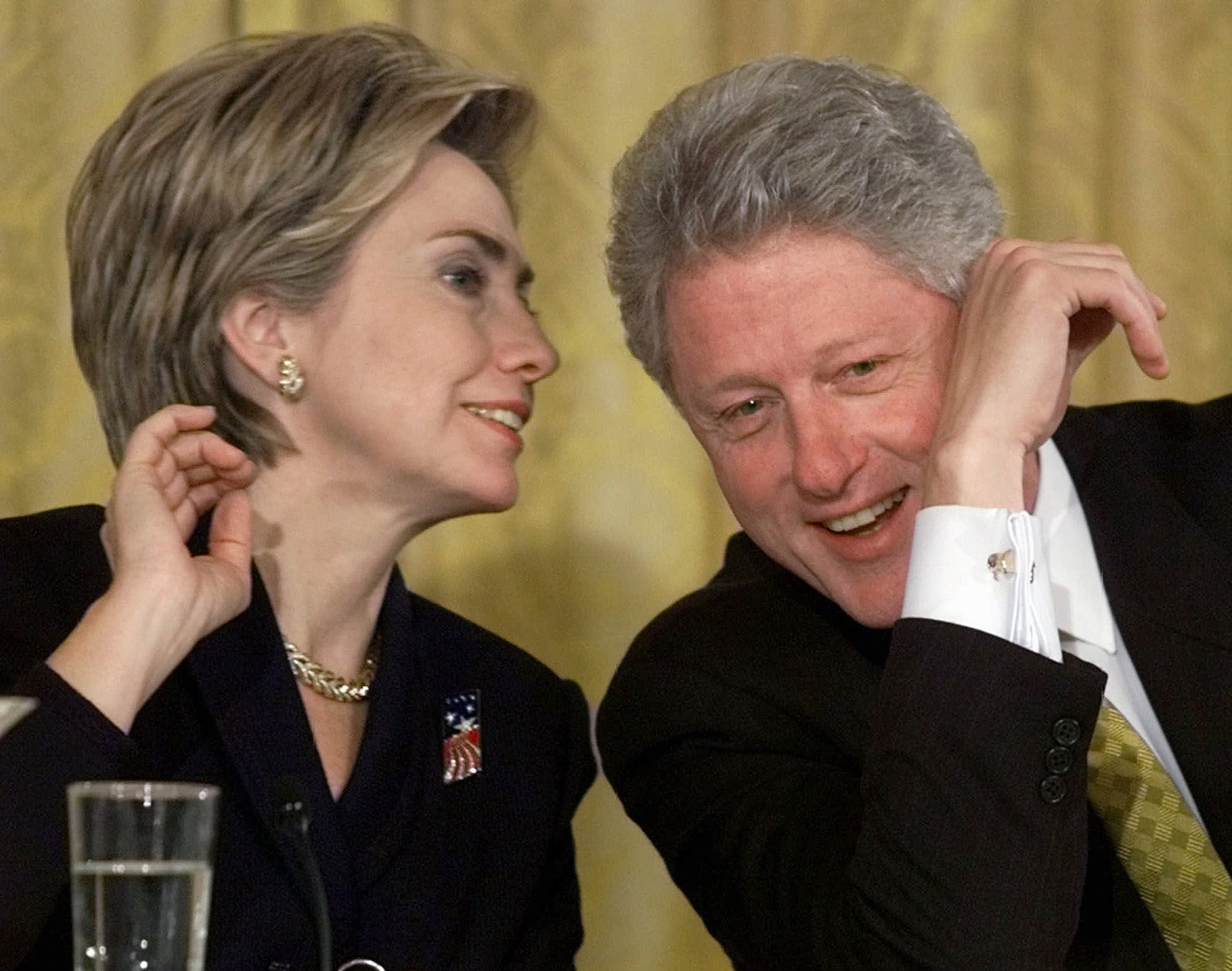 In this Oct. 22, 1999 file photo, President Bill Clinton and first lady Hillary Rodham Clinton talk during the White House Conference on Philanthropy in the East Room of the White House in Washington. As first lady in the final year of the Clinton administration, Hillary Rodham Clinton approved the unveiling of a White House plan to push for tax breaks for private foundations and wealthy charity donors at the same time that the William J. Clinton Foundation was soliciting donations for her husband’s presidential library, recently-released Clinton-era documents show. (AP Photo/Khue Bui, File)