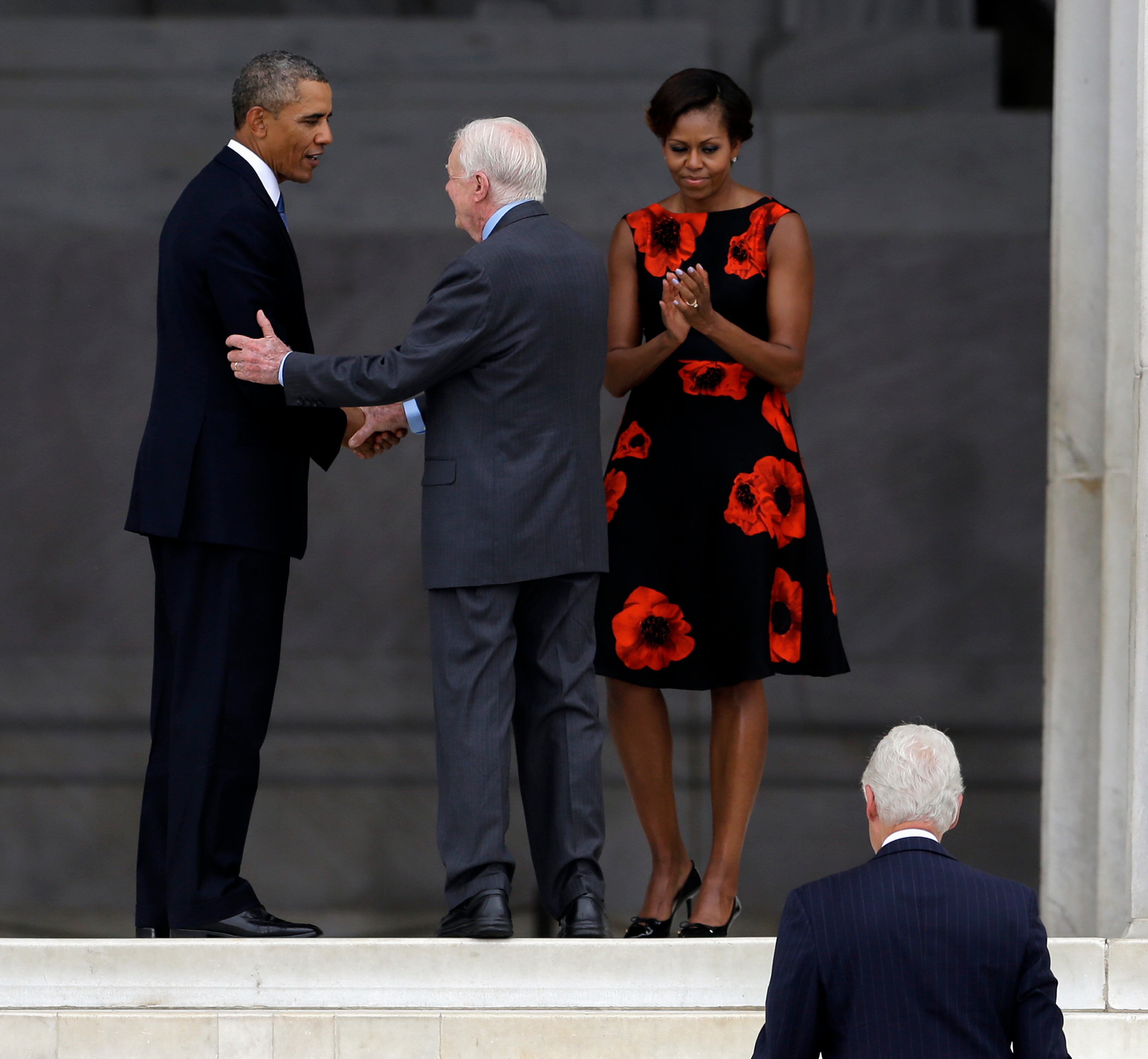 President Barack Obama shakes hands with former President Jimmy Carter as first lady Michelle Obama applauds and former President Bill Clinton walks up the stairs at the Let Freedom Ring ceremony at the Lincoln Memorial in Washington, Wednesday, Aug. 28, 201, to commemorate the 50th anniversary of the 1963 March on Washington for Jobs and Freedom. It was 50 years ago today when Martin Luther King Jr. delivered his "I Have a Dream" speech from the steps of the memorial. (AP Photo/Carolyn Kaster)