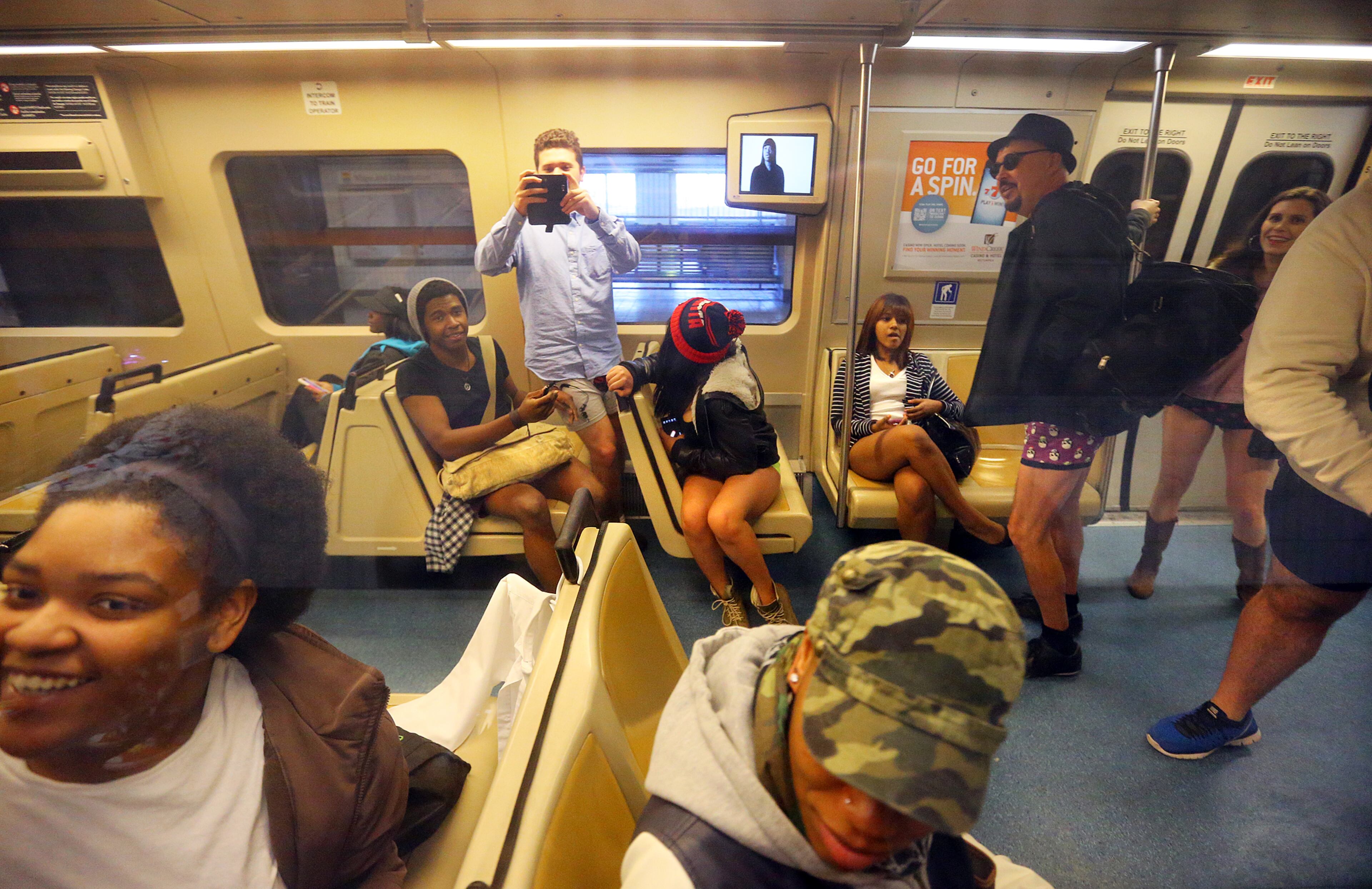 MARTA riders take in the view as pant-free riders board their train at the Civic Center MARTA station. CURTIS COMPTON / CCOMPTON@AJC.COM