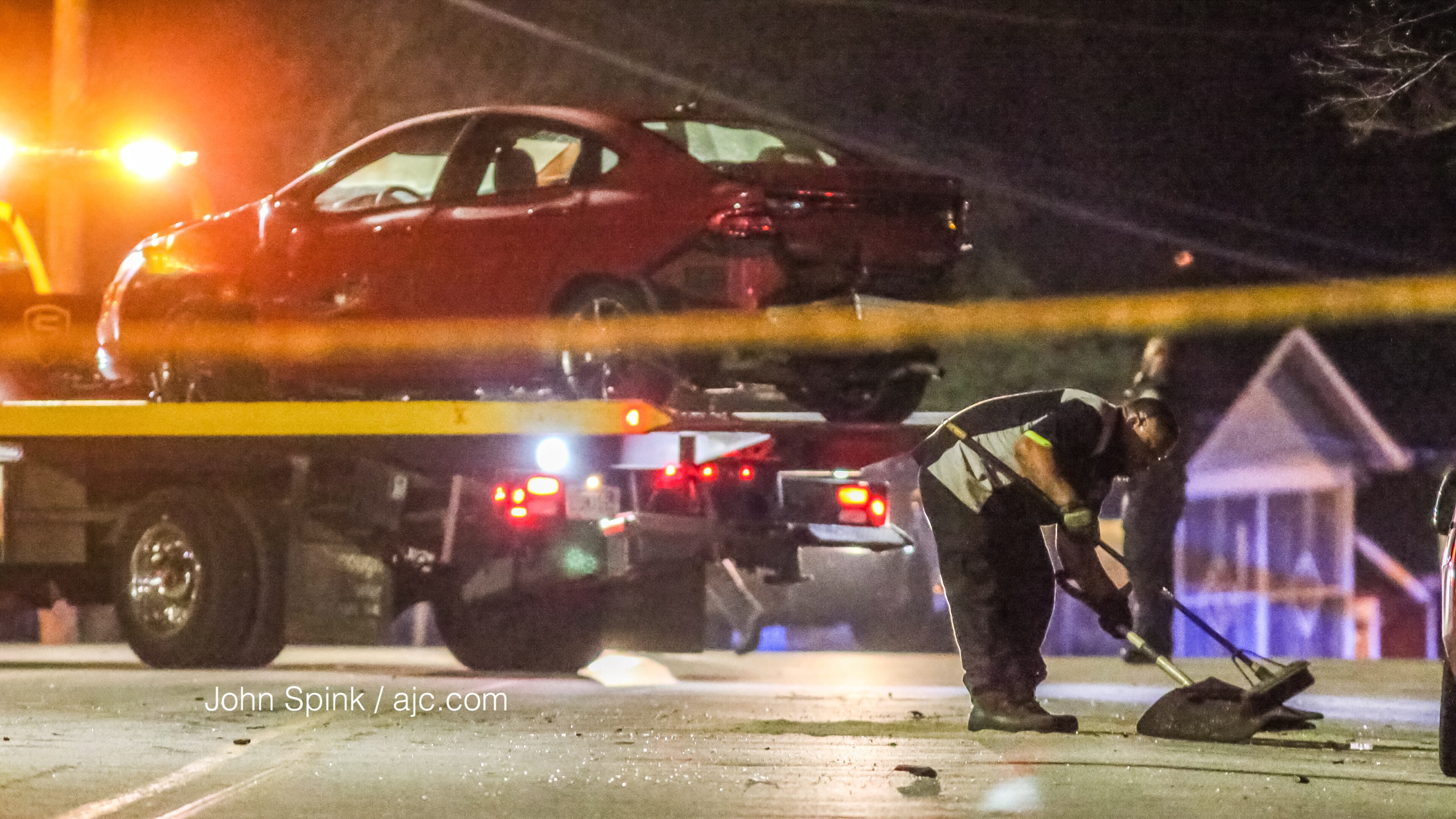 Crews clean up the scene after a driver lost control of a car and crashed into multiple parked cars east of McDaniel Street on Fulton Street, police said. The driver lost control after being shot in the neck just before 2:40 a.m. Thursday.
