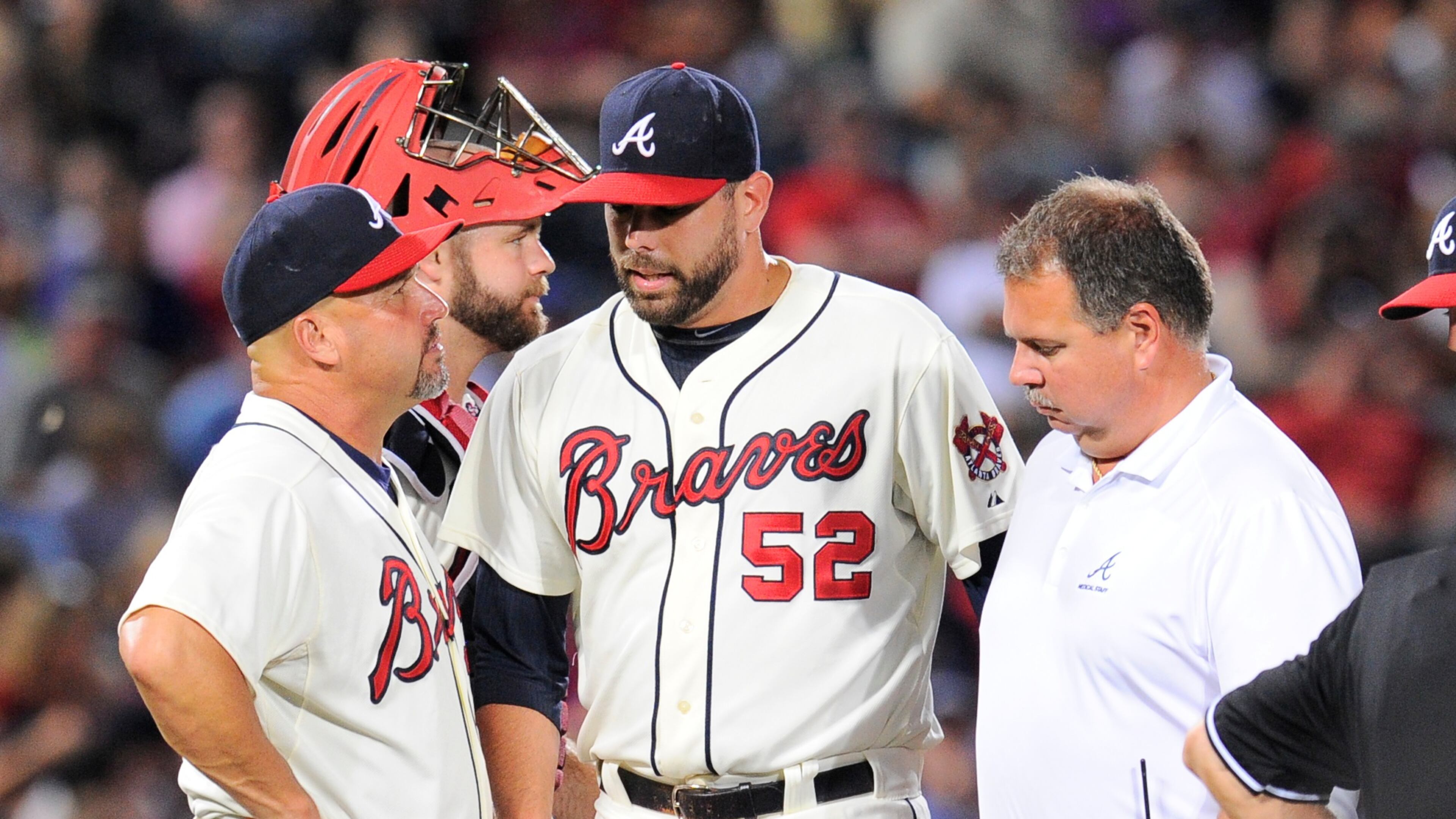 Atlanta Braves manager Fredi Gonzalez (33) removes relief pitcher Jordan Walden (52) from the game after Walden is hit by a line drive off his pitching hand against the Miami Marlins during the ninth inning at Turner Field on Aug. 10, 2013. The Marlins defeated the Braves 1-0.