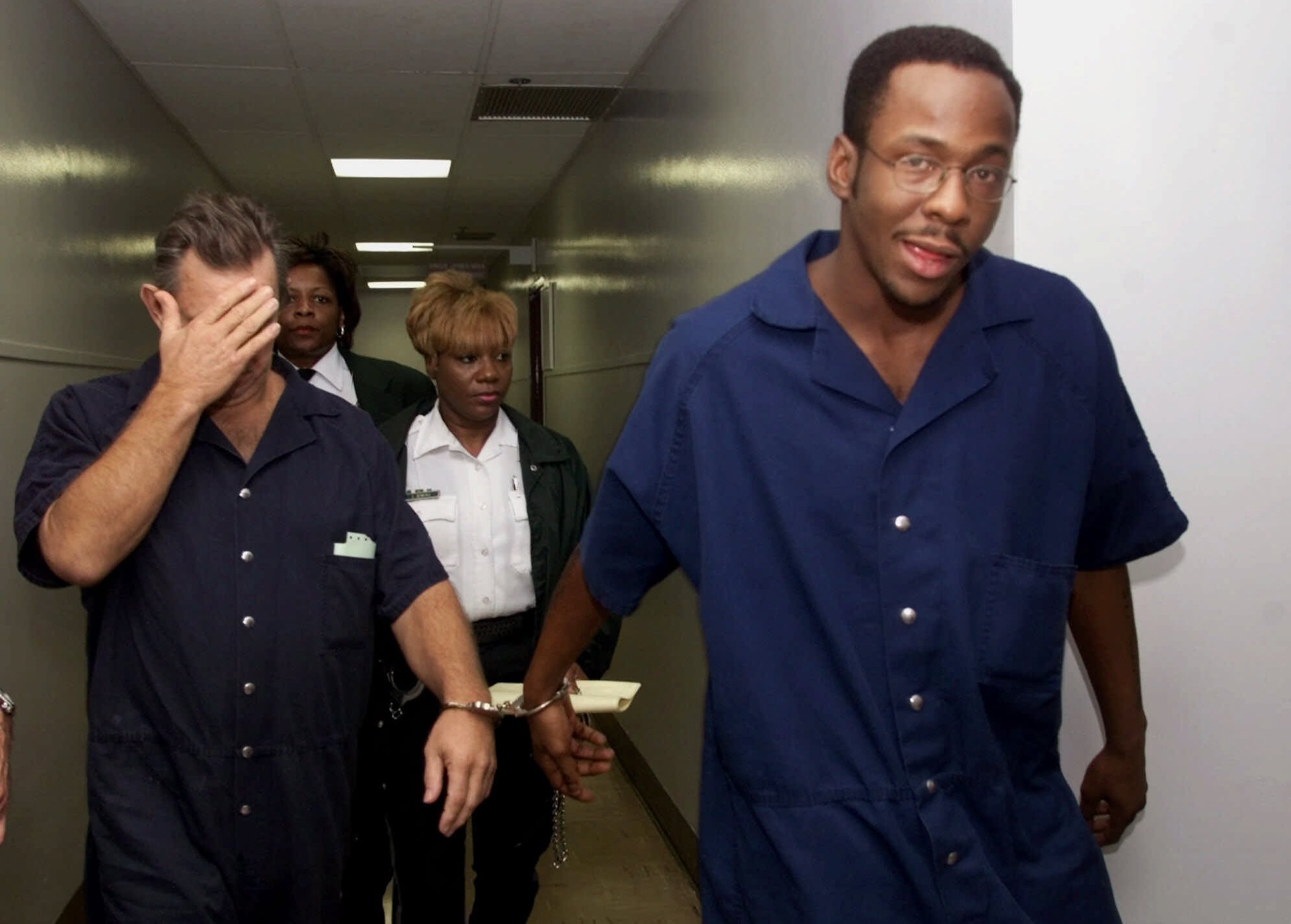 Singer Bobby Brown, right, is escorted from the Broward County Courthouse in Fort Lauderdale, Fla., Monday, May 22, 2000, after being denied bail during a court hearing. Brown must remain in jail until a hearing is held on whether he violated his probation for drunken driving, a judge ruled Monday. Brown smiled, shook his head and looked skyward when Circuit Judge Leonard Feiner refused to grant Brown bond because he was a flight risk. (AP Photo/Tony Gutierrez, POOL)
