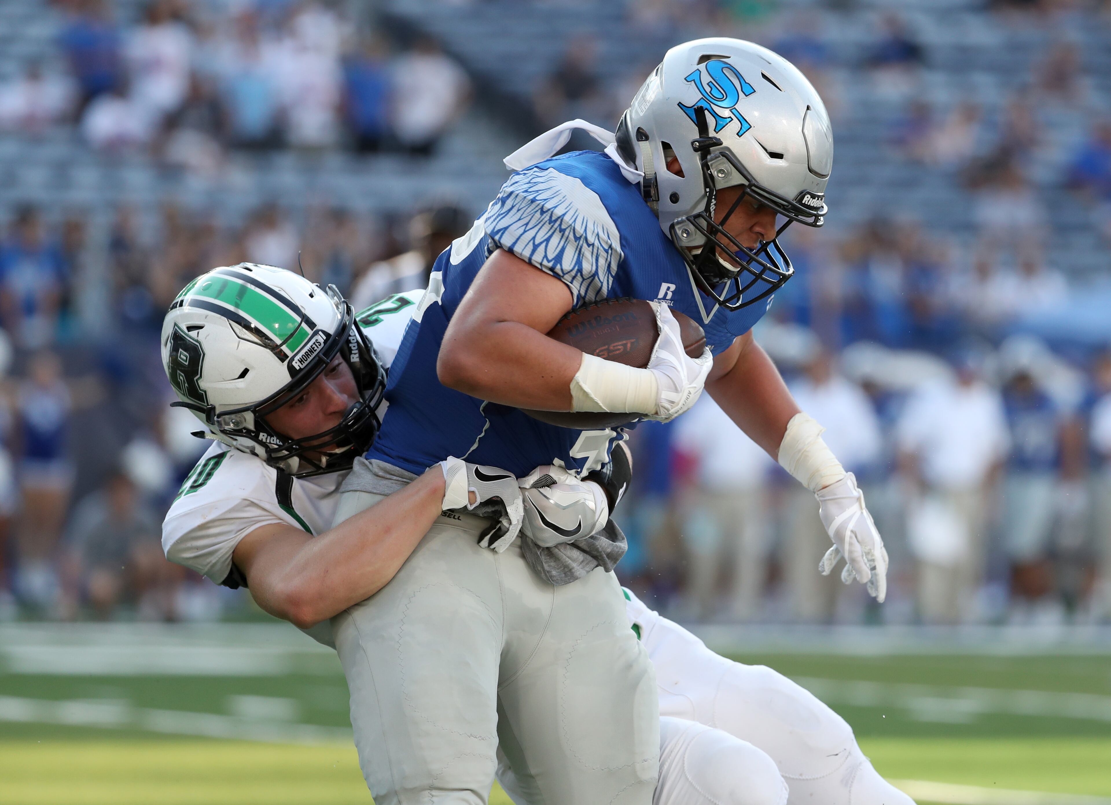 Roswell defensive back Jesse Bridgman (20) tackles South Forsyth running back Daryn Rogers (32) in the first half of Friday's game.