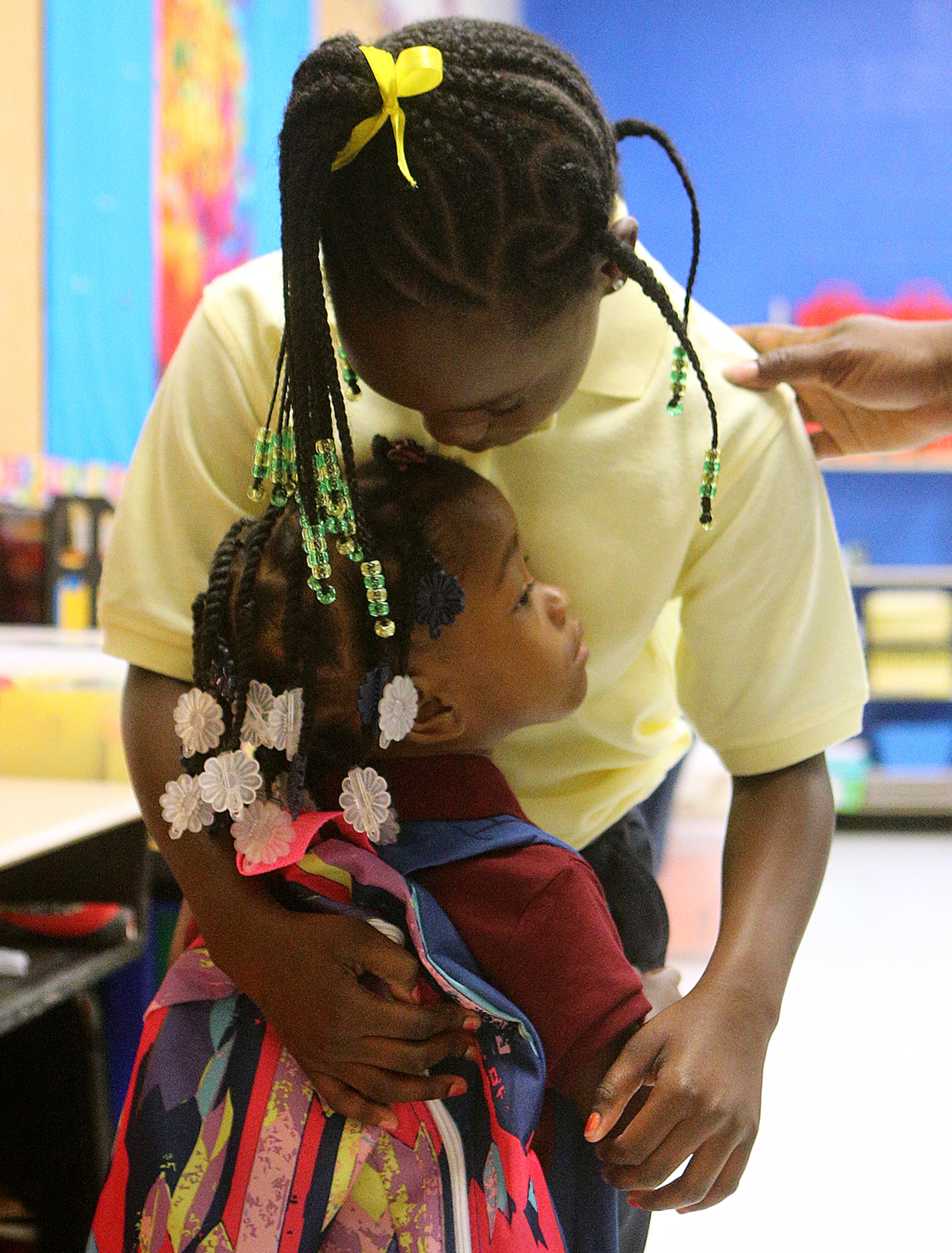 August 7, 2017 Lithonia; Gabrielle Reeves, 7, gets a hug goodbye from her 3-year-old sister Rmya Walker as she arrives at her second grade class for the first day of school at Edward L Bouie Elementary School on Monday, August 7, 2017, in Lithonia. Curtis Compton/ccompton@ajc.com