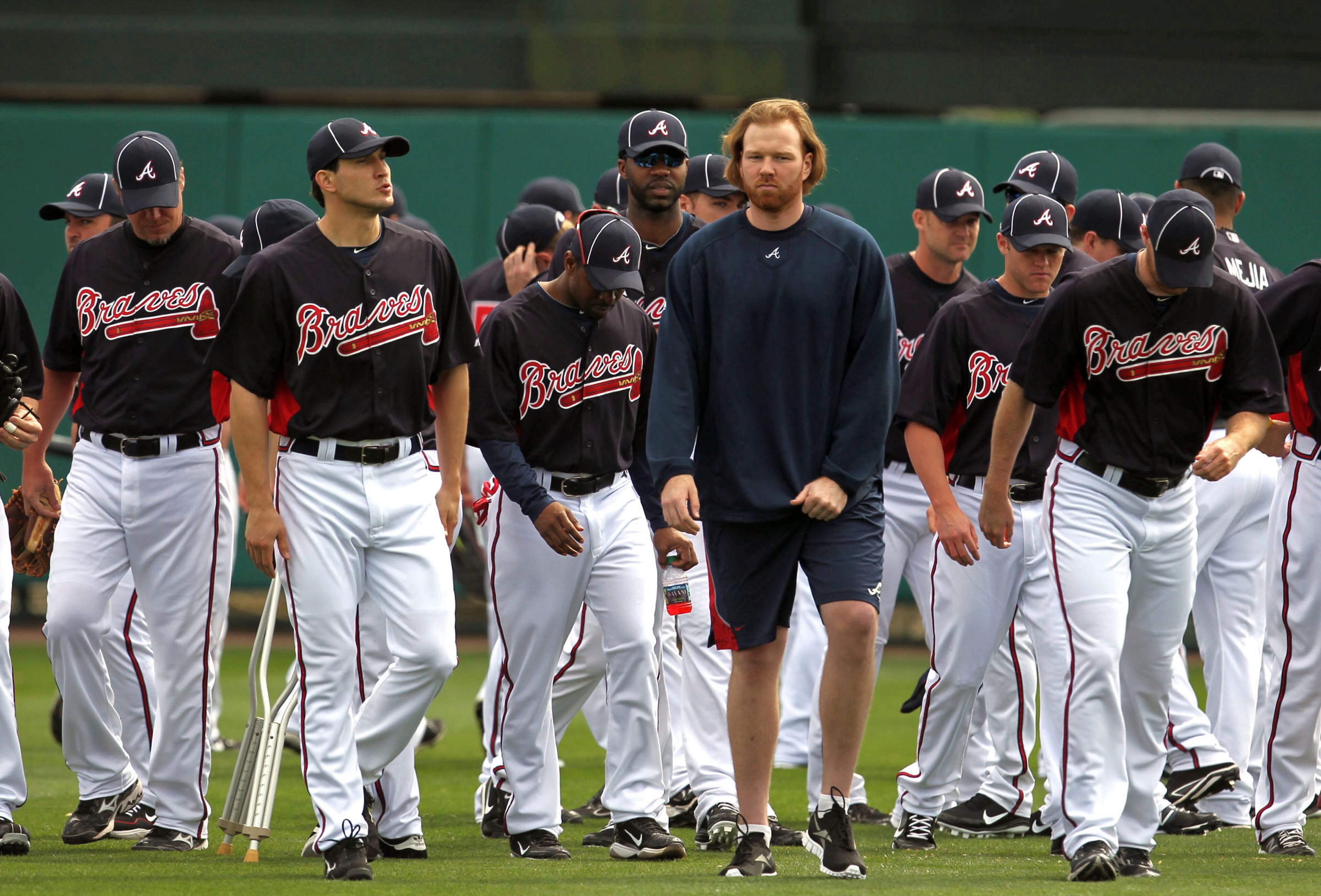Not wearing a uniform, Atlanta Braves pitcher Tommy Hanson walks with teammates after the annual team meeting in center field to start the first full squad workout at Champion Stadium in the ESPN Wide World of Sports Complex Saturday afternoon in Lake Buena Vista, Fl., Feb. 25, 2012. Hanson is recovering from a concussion caused by a one-car accident Monday Feb. 20, 2012. This was the first time Hanson came onto the field this camp. Jason Getz jgetz@ajc.com