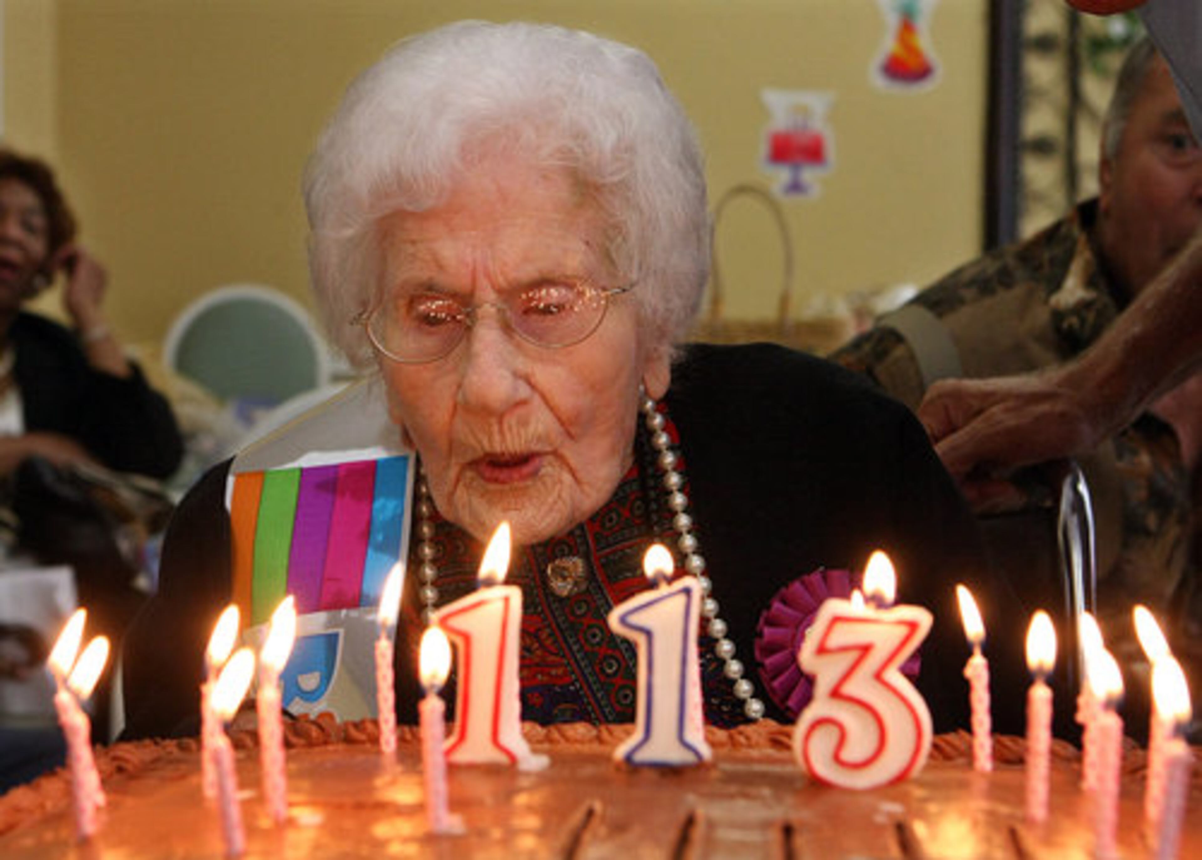 Besse Cooper blows out the candles on her cake. When asked the secret of her longevity Ms. Cooper said " I mind my own business and I don't eat junk food."