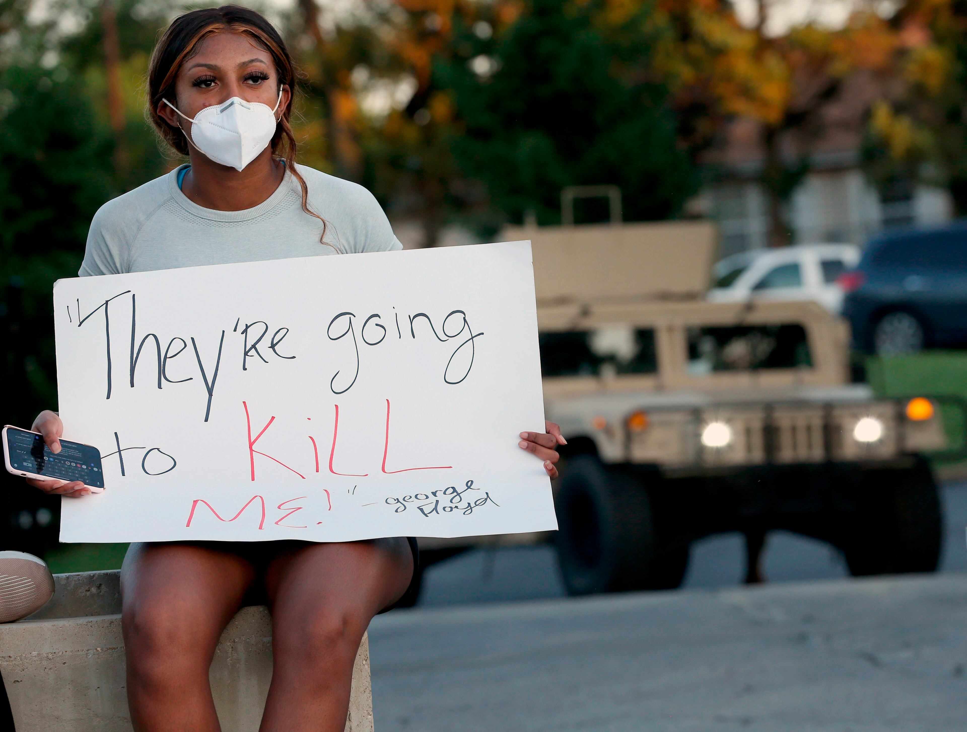 Kennedy Mitchum protests outside the Florissant Police Department with others in Missouri. Merriam-Webster is revising its definition of racism after Mitchum's emails claimed it fell short of including the systemic oppression of certain groups of people.