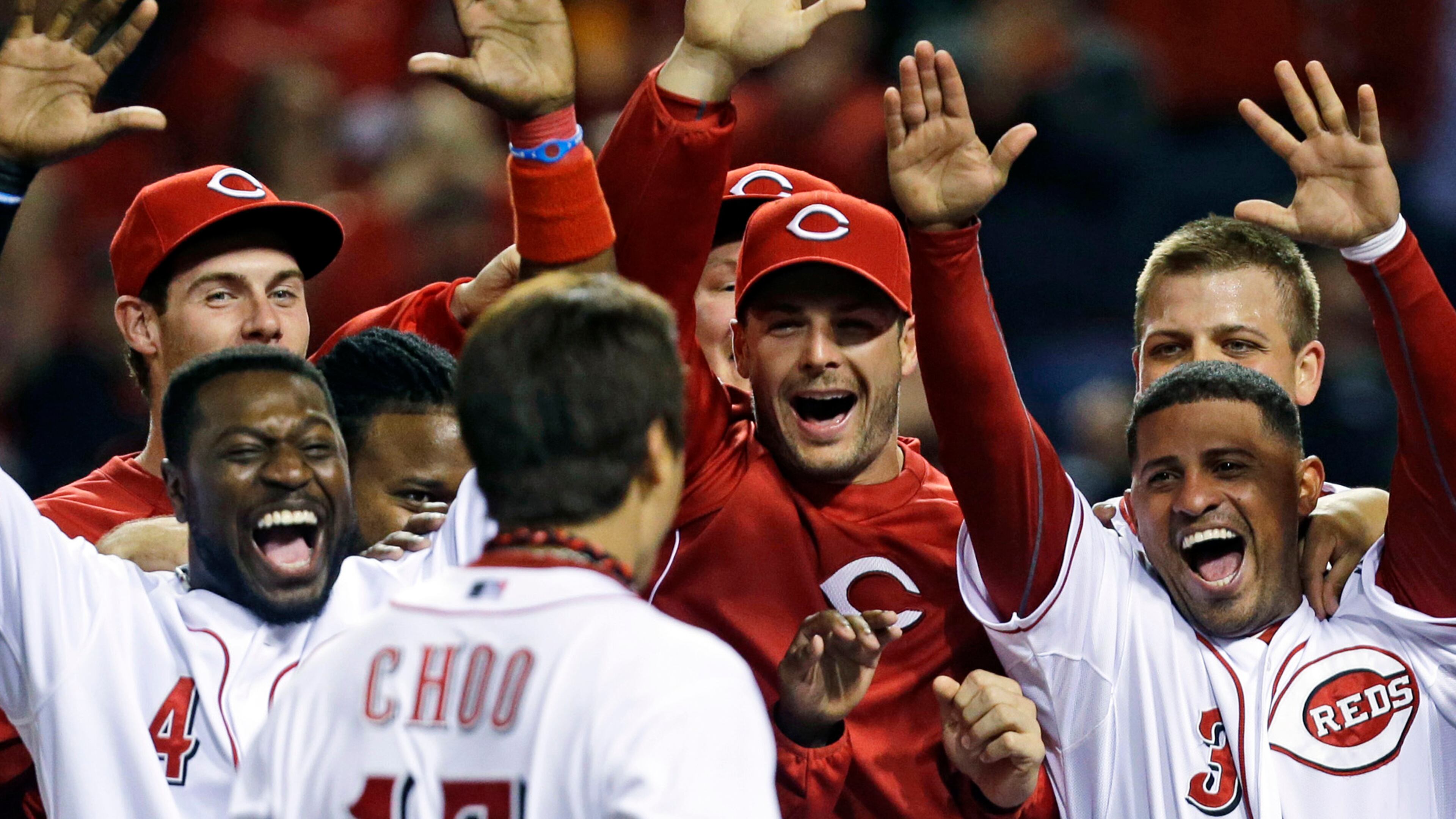 Cincinnati Reds' Shin-Soo Choo (17) is greeted at home plate after hitting a walk-off home run off Atlanta Braves relief pitcher Craig Kimbrel in the ninth inning of a baseball game, Tuesday, May 7, 2013, in Cincinnati. Cincinnati won 5-4. (AP Photo/Al Behrman)