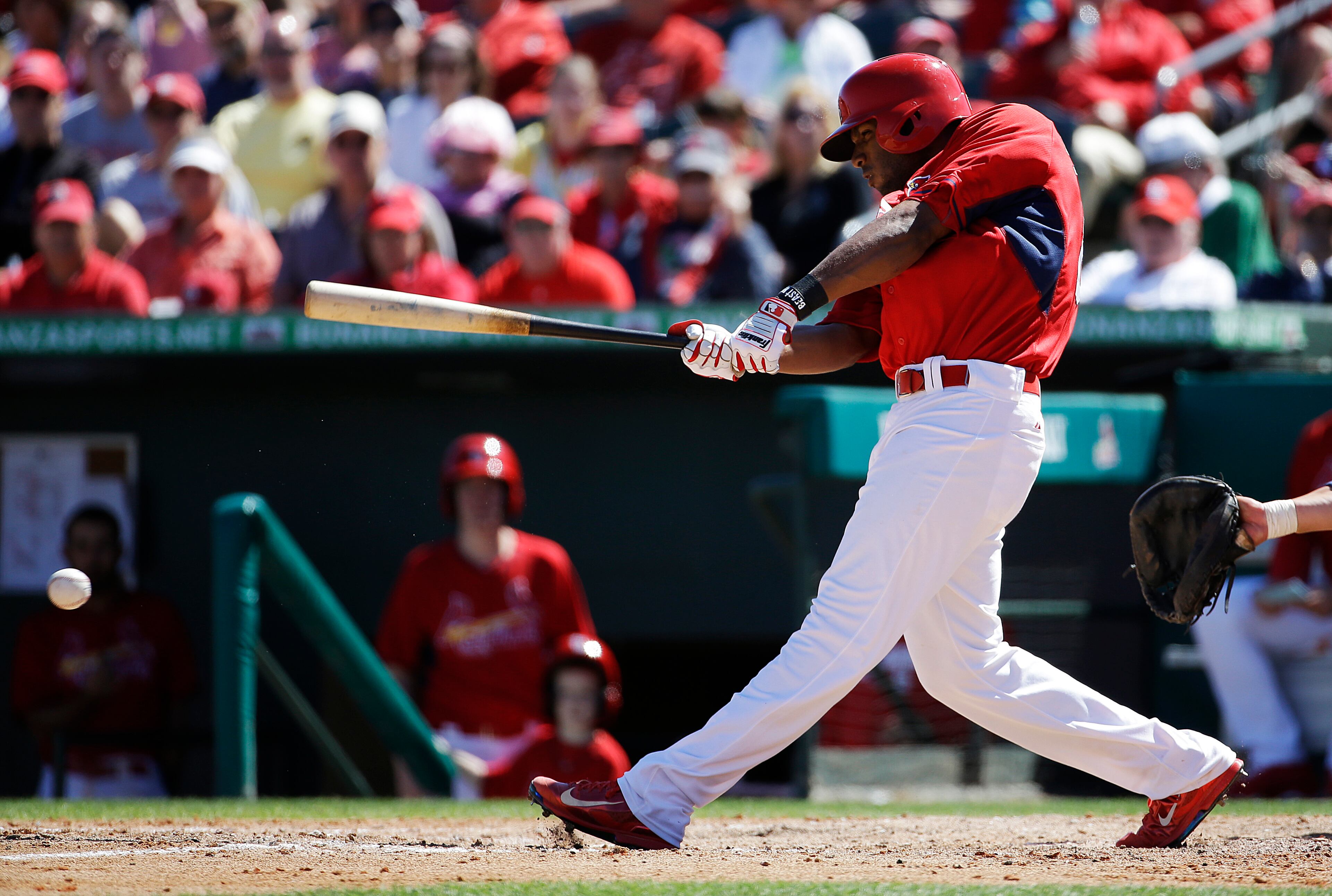 St. Louis Cardinals' Xavier Scruggs doubles to score three runs in the sixth inning of an exhibition spring training baseball game against the Atlanta Braves, Thursday, March 13, 2014, in Jupiter, Fla.
