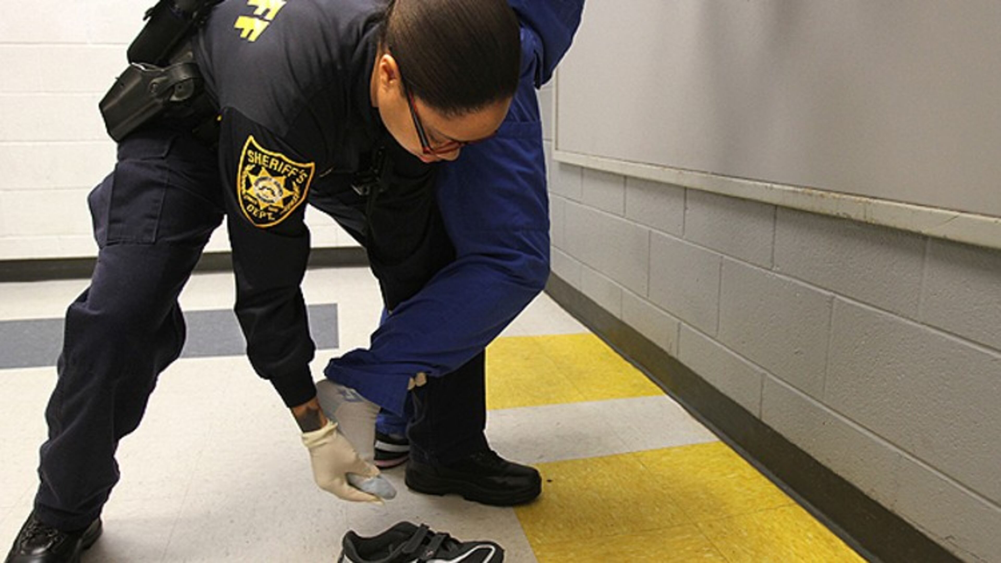 Deputy P. Brown performs a search at the Gwinnett County Jail, which participates in the federal 287(g) immigration enforcement program.