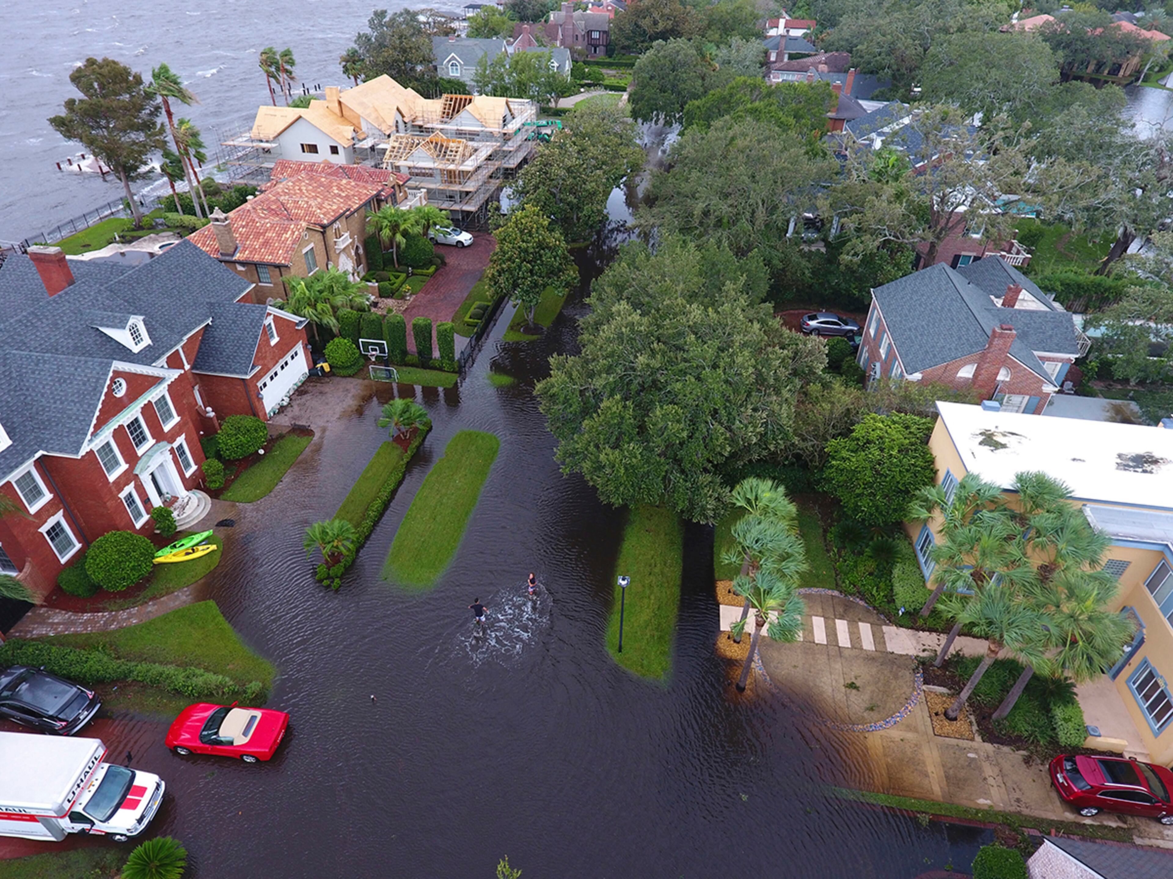 Jacksonville, Fla.: In this Monday, Sept. 11, 2017, photo provided by DroneBase, people trudge through floodwaters in the aftermath of Hurricane Irma in Jacksonville, Fla. In a parting blow to the state, the storm caused record flooding in the Jacksonville area. (DroneBase via AP)