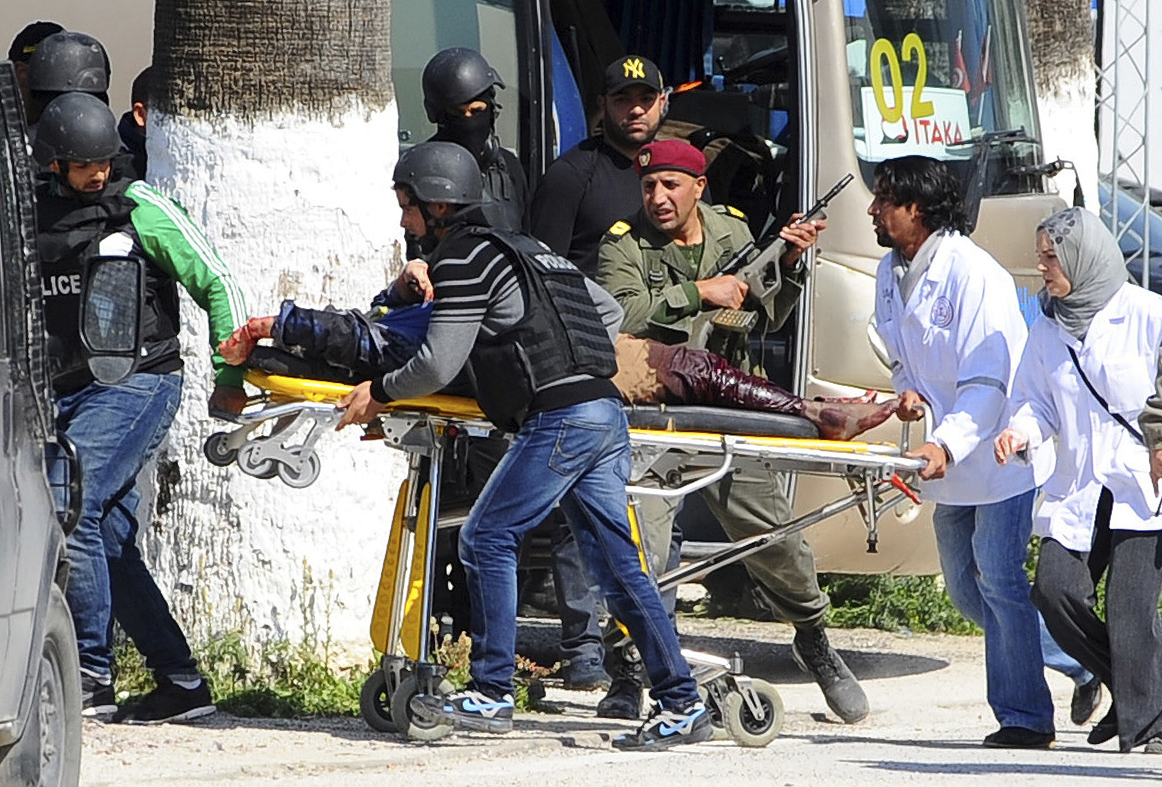 A victim is being evacuated by rescue workers outside the Bardo museum in Tunis, Wednesday, March 18, 2015 in Tunis, Tunisia. Gunmen opened fire at a leading museum in Tunisia's capital, killing 19 people including 17 tourists, the Tunisian Prime Minister said. A later raid by security forces left two gunmen and one security officer dead but ended the standoff, Tunisian authorities said. (AP Photo/Hassene Dridi)