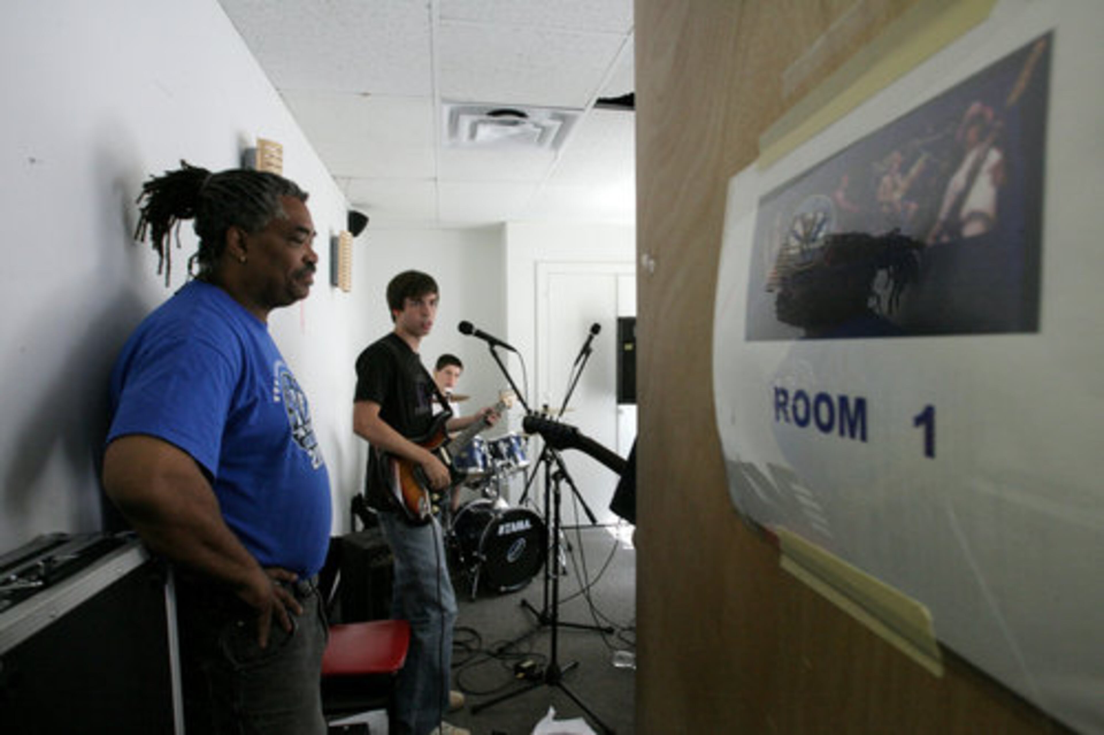 Jones checks on the band Highway, including members Casey Williams (center) and Joey Ziegler. He said he appreciates the kids' raw talent and enthusiasm. "What they're lacking is help and instruction," he said. "I enjoy being able to watch these kids learn and grow."