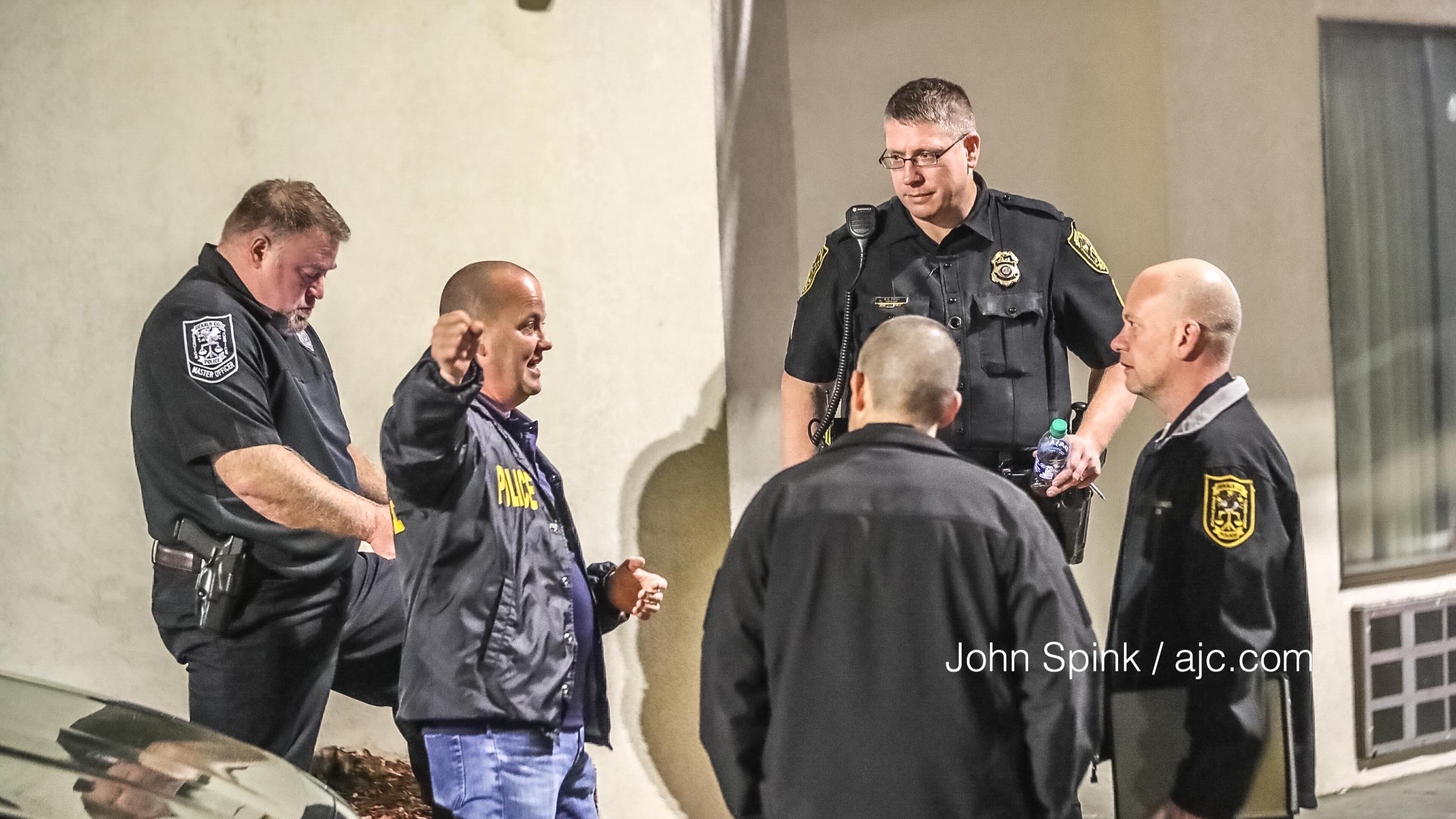 DeKalb County investigators gather at the scene of a deadly double shooting Friday morning at the Motel 6 on Chamblee Tucker Road.