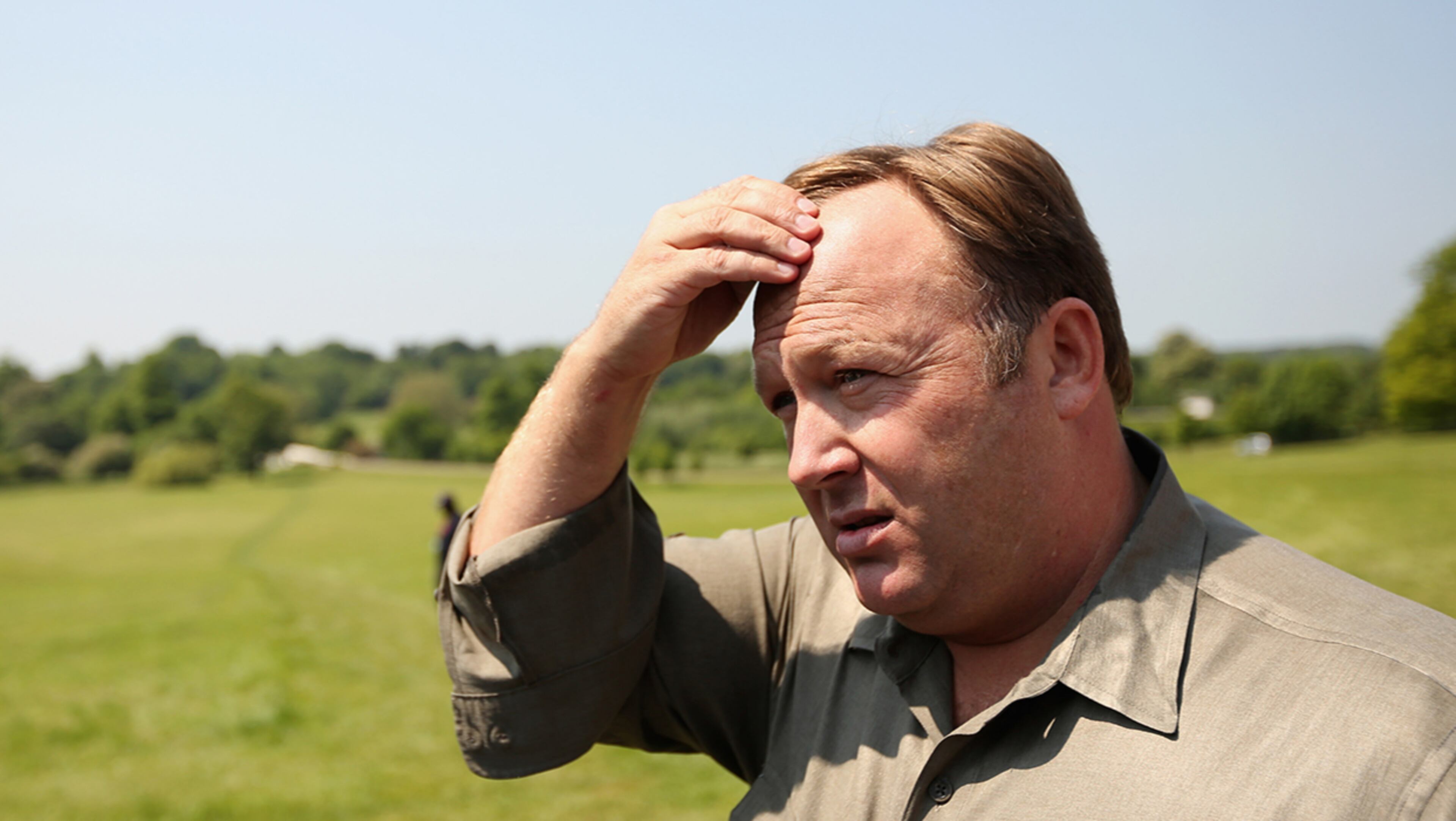 WATFORD, ENGLAND - JUNE 06: Alex Jones, an American radio host, author and conspiracy theorist, addresses media and protesters in the protester encampment outside The Grove hotel, which hosted the annual Bilderberg conference, on June 6, 2013 in Watford, England. The traditionally secretive conference, which has taken place since 1954, was expected to be attended by politicians, bank bosses, billionaires, chief executives and European royalty. (Photo by Oli Scarff/Getty Images)