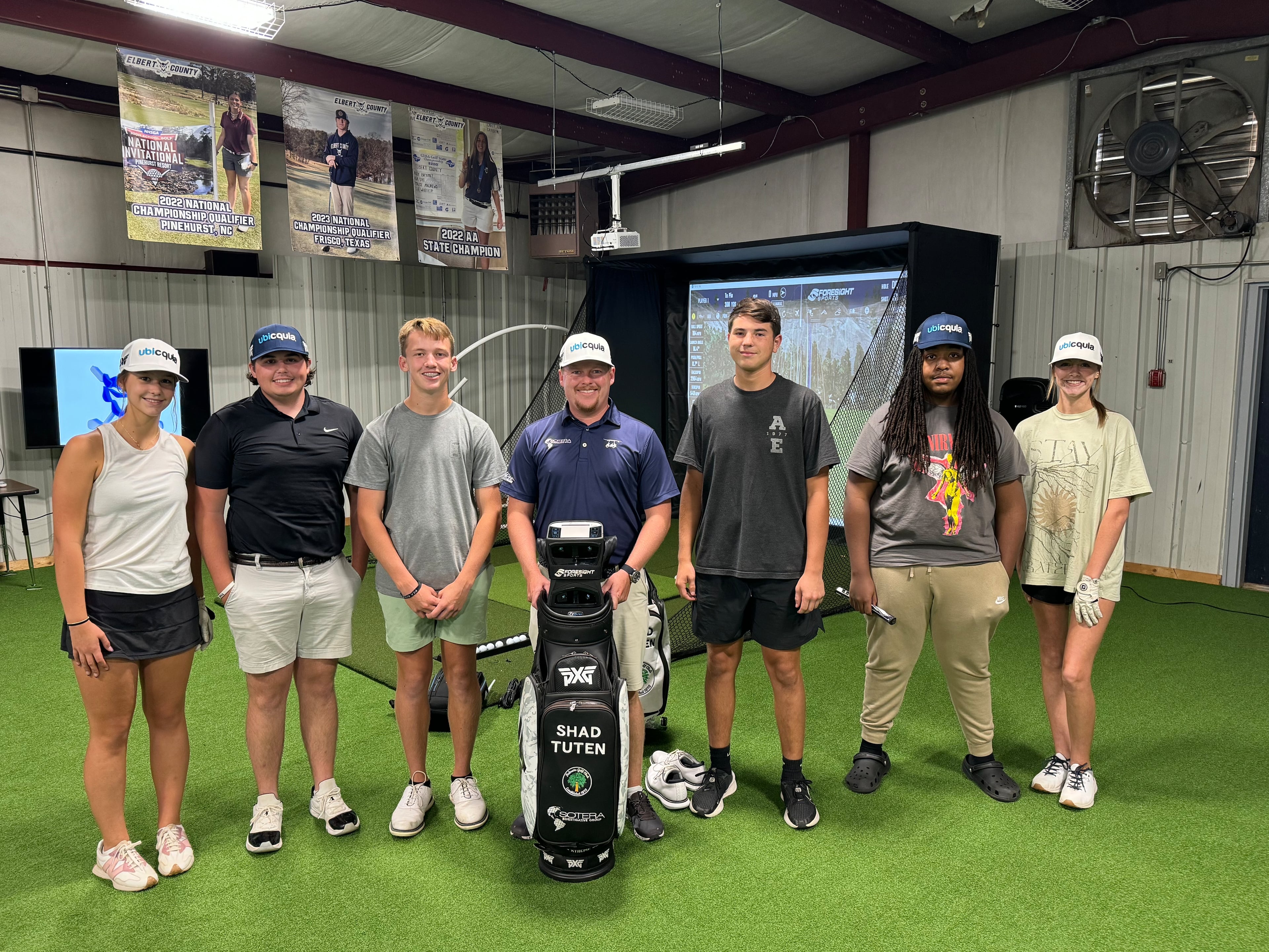 Players on the Elbert County golf team show off their new work stations. In the center is Elberton native Shad Tuten, who donated one of the stations.