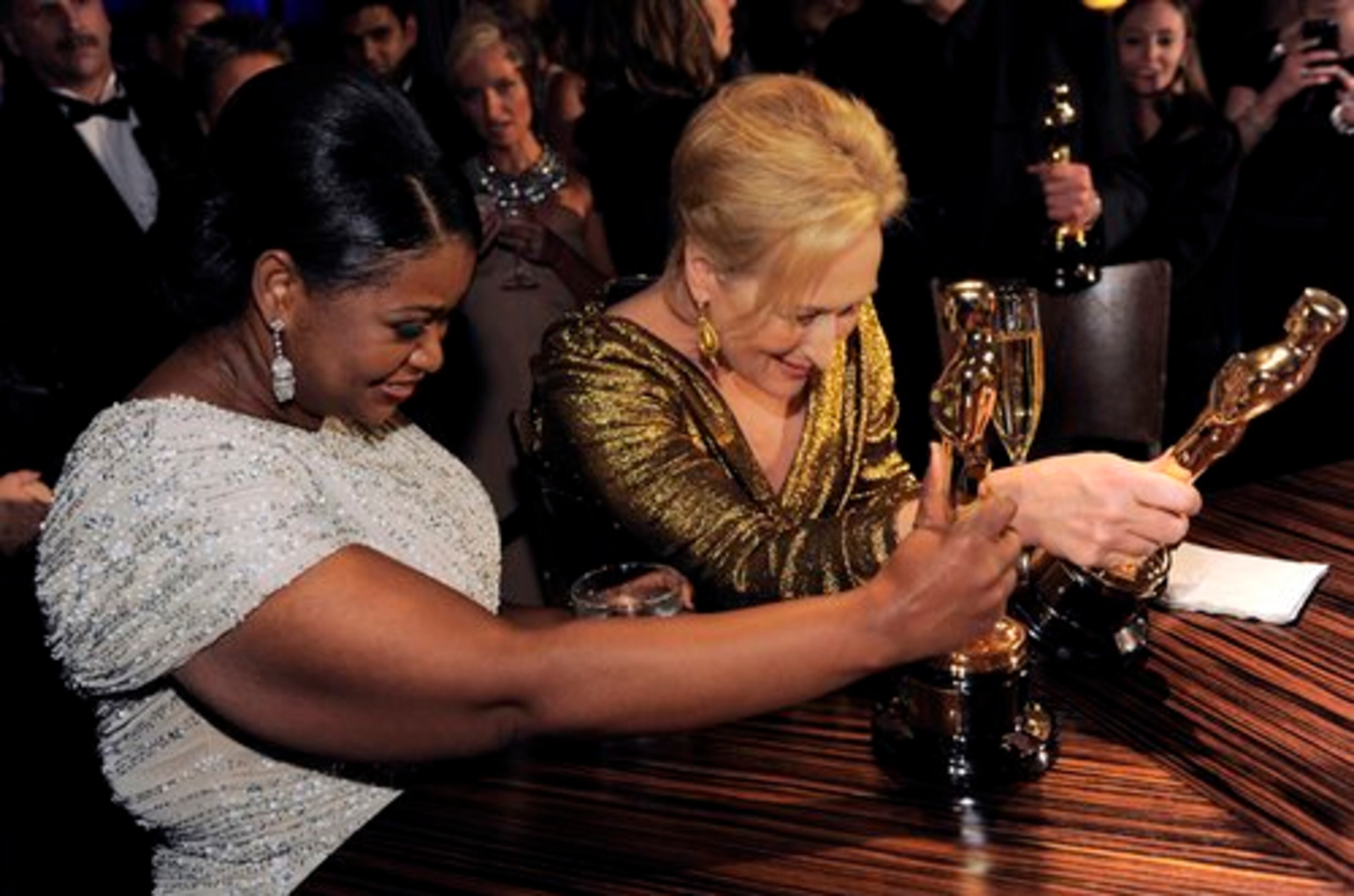 Octavia Spencer with the Oscar for best actress in a supporting role for "The Help" and Meryl Streep with the Oscar for best actress in a leading role for "The Iron Lady" examine their trophies.