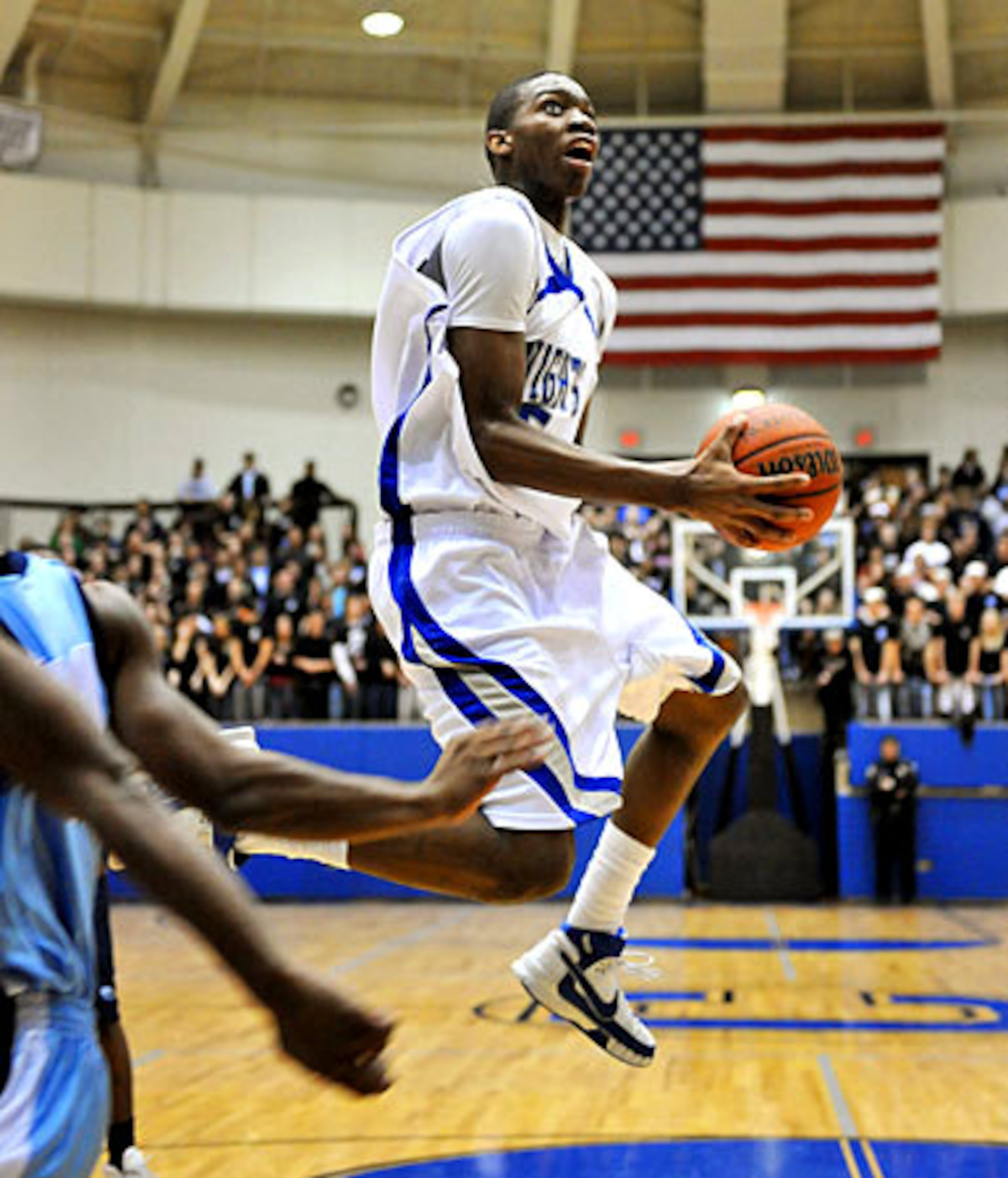 Centennial's Kamren Belin elevates in the first half of their first-round boys state basketball tournament game against Meadowcreek Friday.