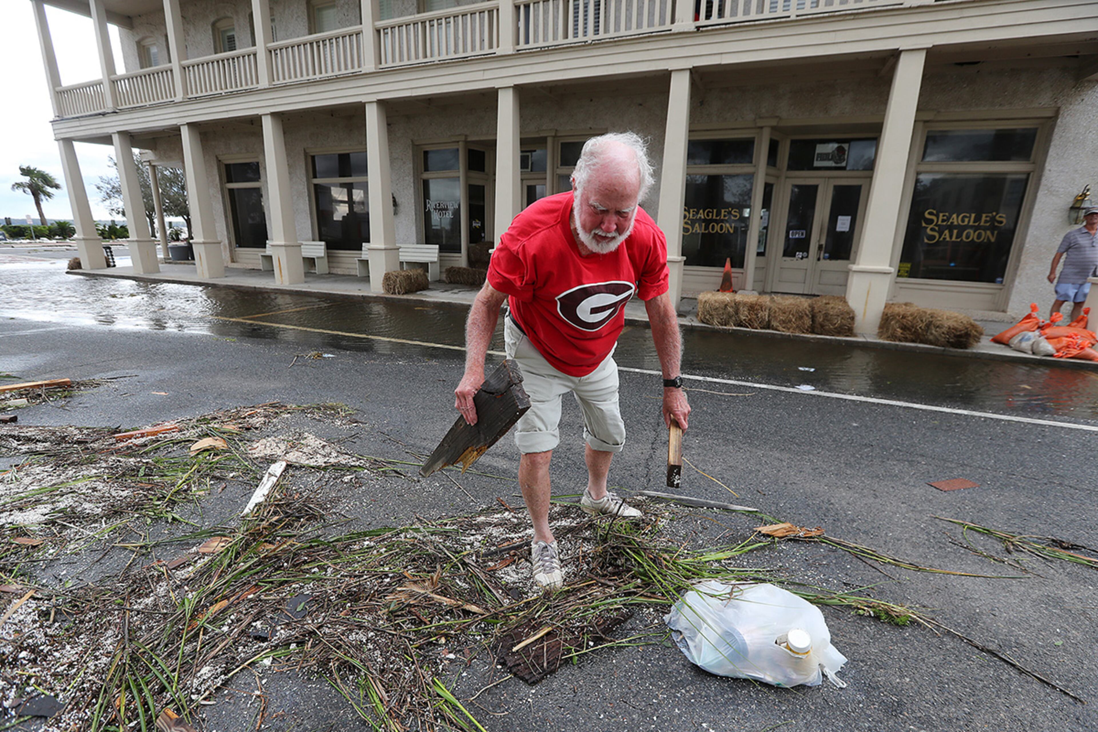 September 11, 2017 St. Marys: Owner Jerry Brandon cleans up debris after flooding begins to subside at his Riverview Hotel after Hurricane Irma swept through the town on Monday, September 11, 2017, in St. Marys. The Georgia fan drove all night to get back to his hotel after attending the Georgia game at Notre Dame just to weather the storm. Curtis Compton/ccompton@ajc.com