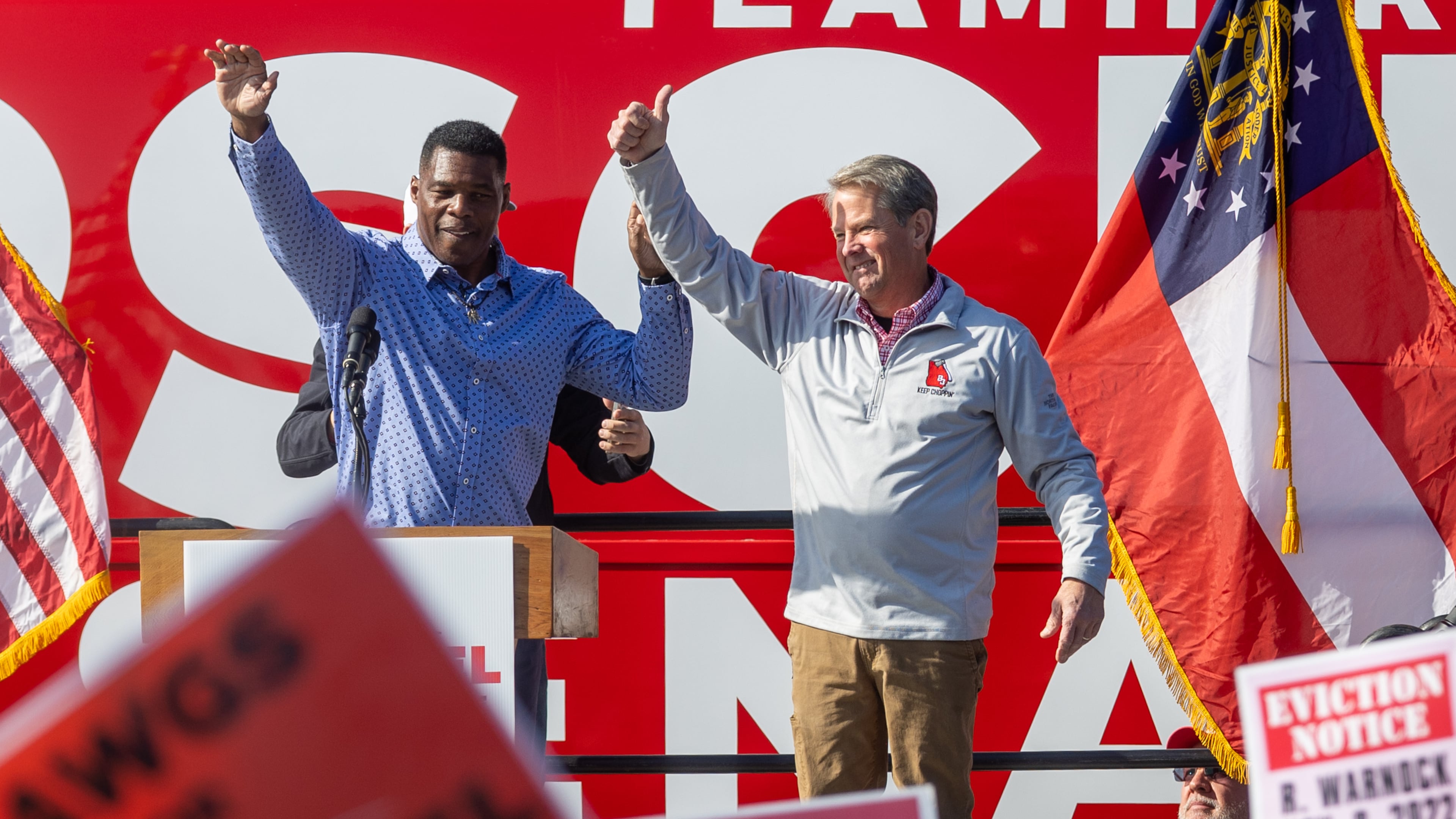 Gov. Brian Kemp (right) and Republican U.S. Senate hopeful Herschel Walker wave to the crowd at the end of a rally in Smyrna Saturday, November 19, 2022. (Steve Schaefer/steve.schaefer@ajc.com)