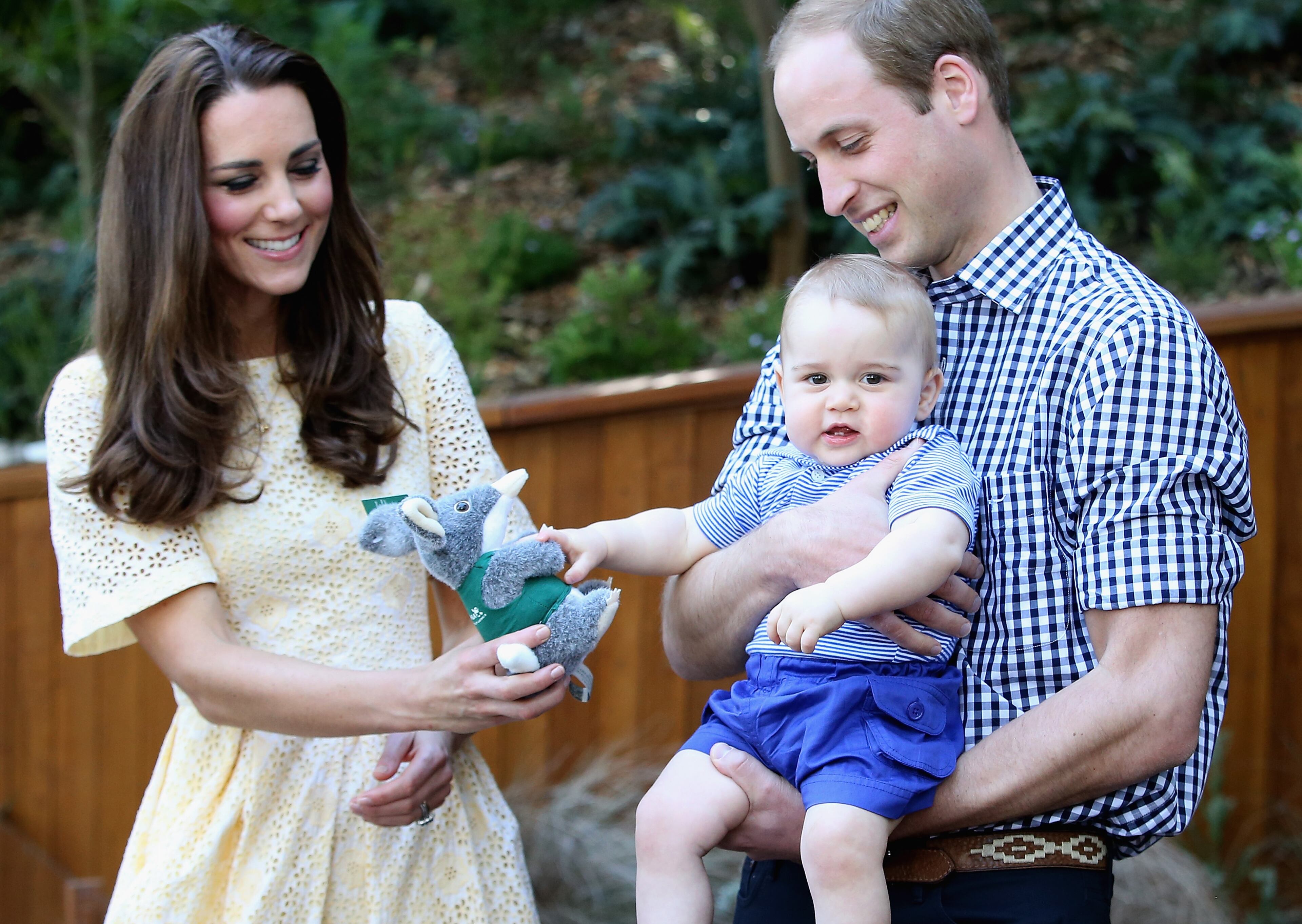 Prince William, Duke of Cambridge, holds Prince George of Cambridge as Catherine, Duchess of Cambridge, gives him a toy bilby during a visit to the Bilby Enclosure at Taronga Zoo on April 20, 2014, in Sydney, Australia. The Duke and Duchess of Cambridge are on a three-week tour of Australia and New Zealand, the first official trip overseas with their son, Prince George of Cambridge.
