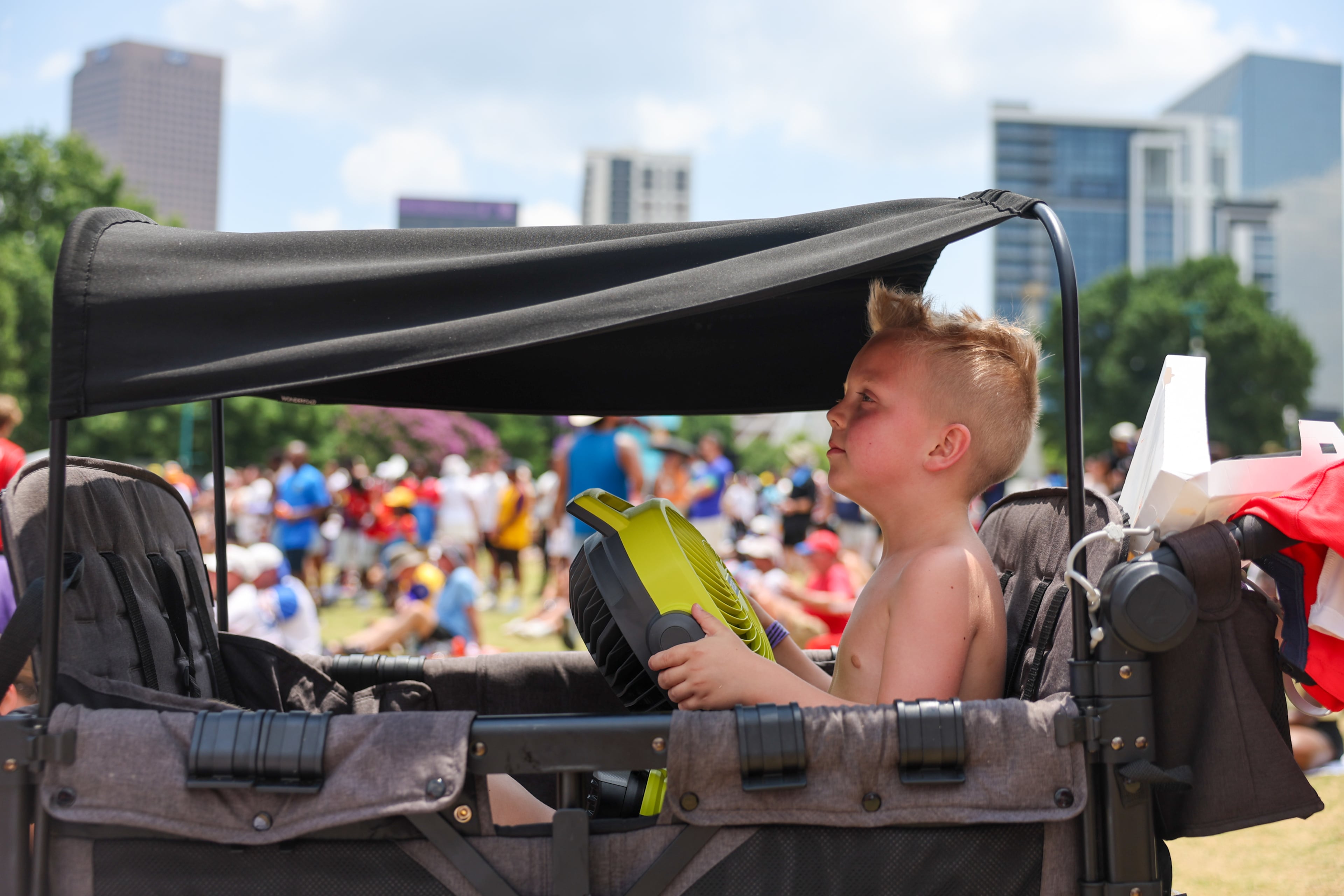 Archie Clements, 6, cools off at Fan Fest in Centennial Olympic Park in Atlanta in the second half of the England versus Congo FIFA World Cup game on July 1, 2026. The game was played in Atlanta Stadium (Mercedes Benz Stadium) for the knockout round of 32. England won 2-1. (Arvin Temkar/AJC)