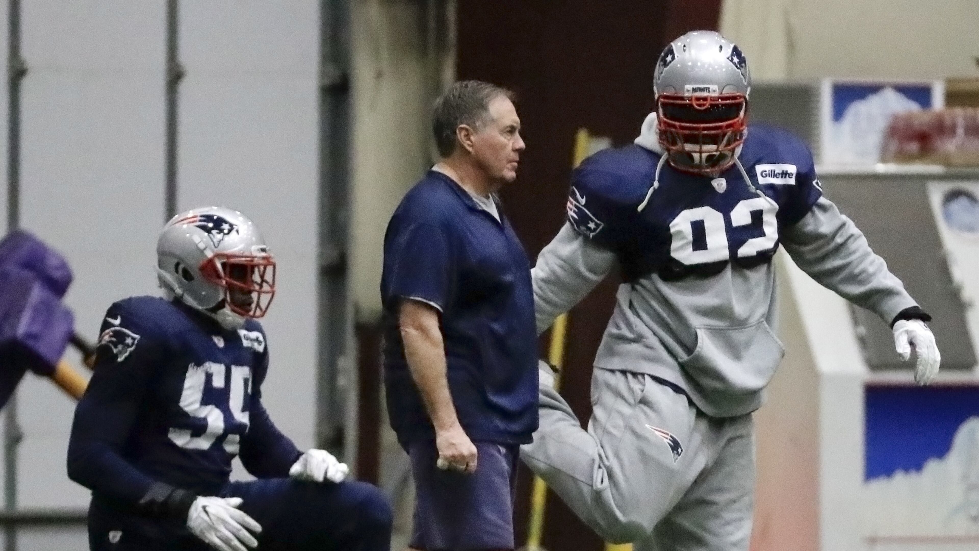 New England Patriots head coach Bill Belichick talks with outside linebacker James Harrison (92) during a practice Wednesday, Jan. 31, 2018, in Minneapolis. The Patriots are scheduled to face the Philadelphia Eagles in the NFL Super Bowl 52 football game Sunday, Feb. 4. (AP Photo/Mark Humphrey)