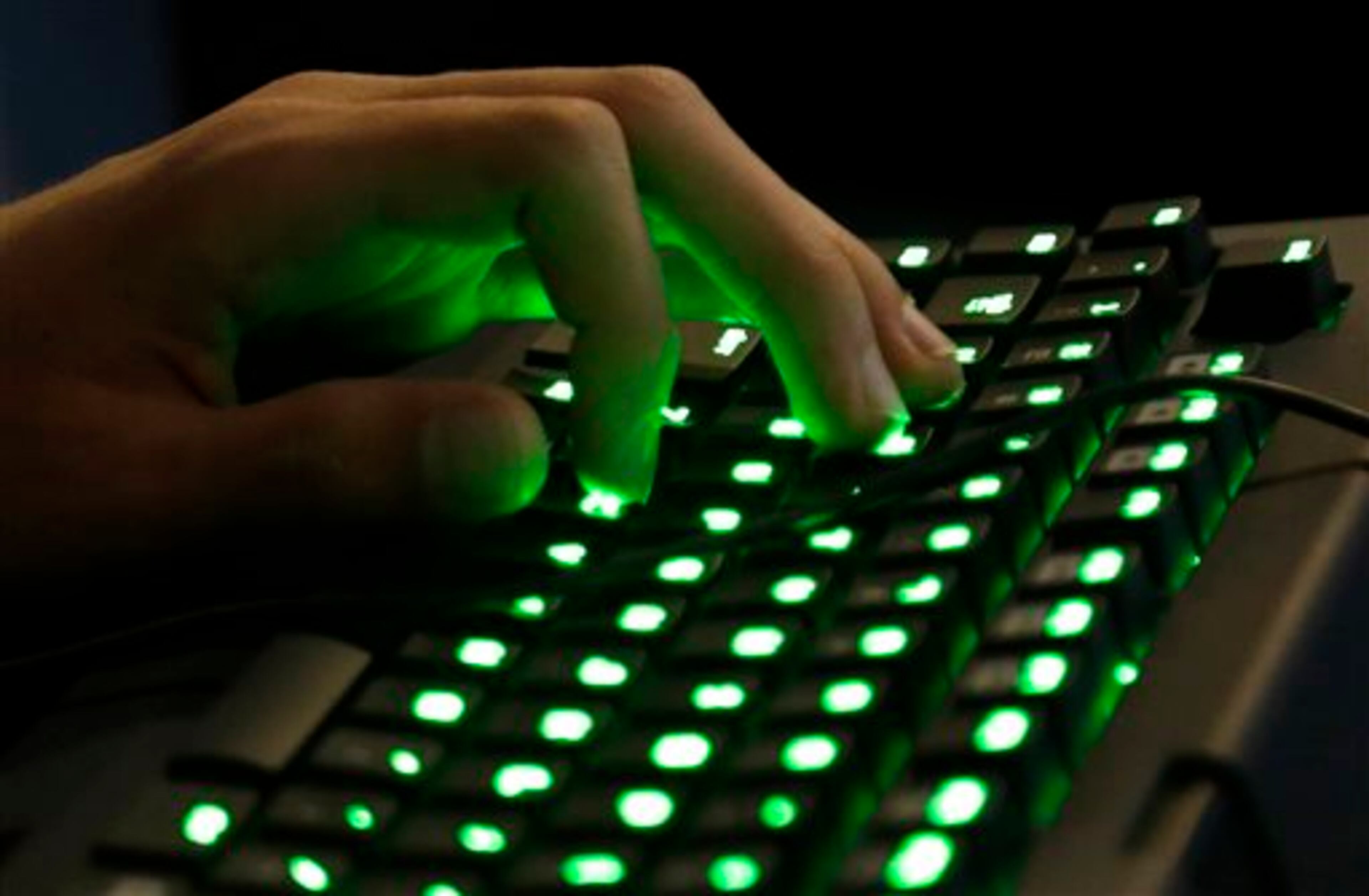 A gamer's hand rests on an illuminated keyboard Friday, Aug. 29, 2014, at the Penny Arcade Expo, a fan-centric celebration of gaming in Seattle. The event is expected to be attended by roughly 85,000 gamers and will include concerts, game tournaments and previews of upcoming titles. (AP Photo/Ted S. Warren)