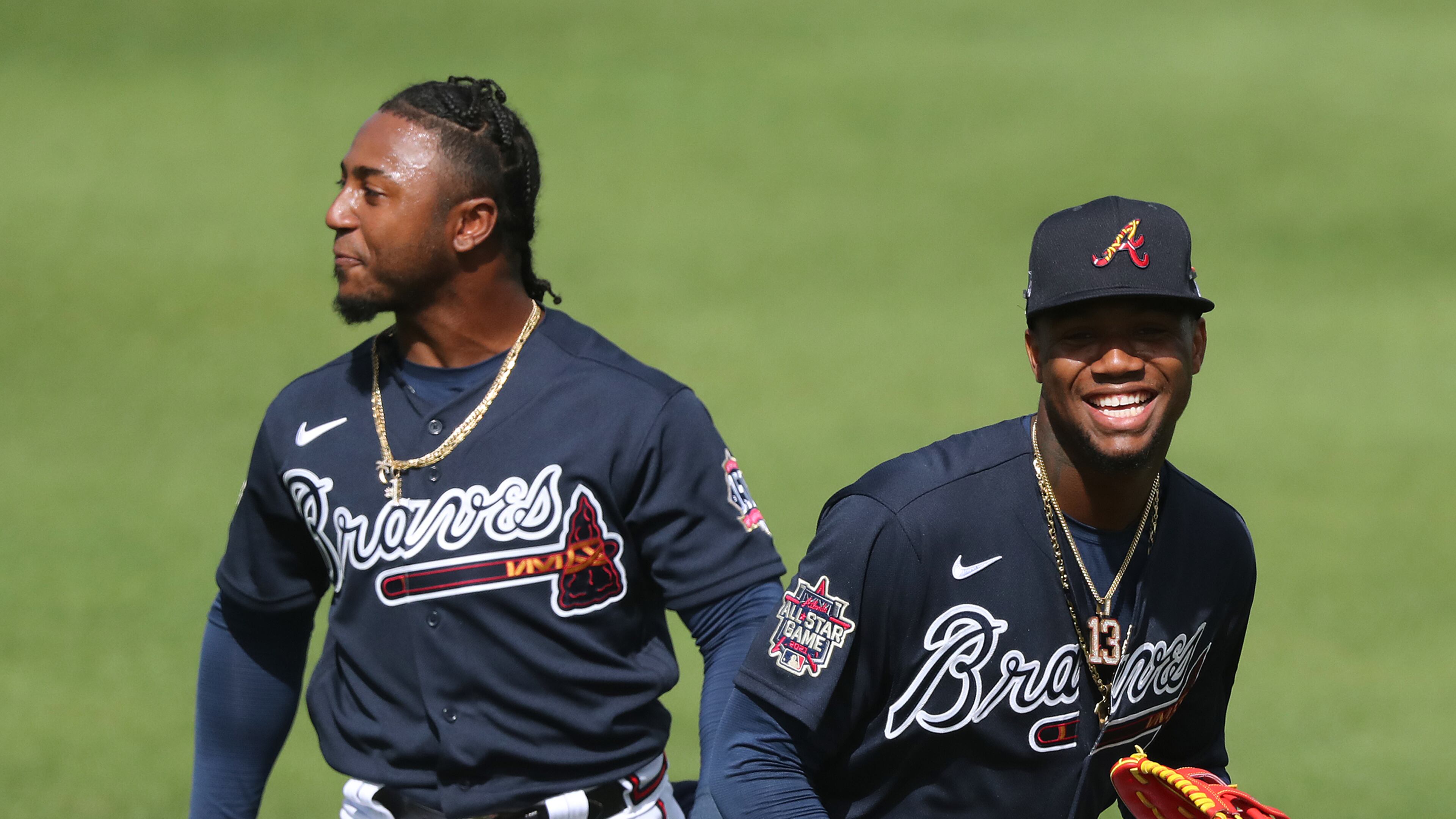 022421 North Port: Atlanta Braves second baseman Ozzie Albies (left) and outfielder Ronald Acuna share a laugh in shallow right field after avoiding the collision while calling a fly ball during team practice at CoolToday Park on Wednesday, Feb. 24, 2021, in North Port. Curtis Compton / Curtis.Compton@ajc.com”