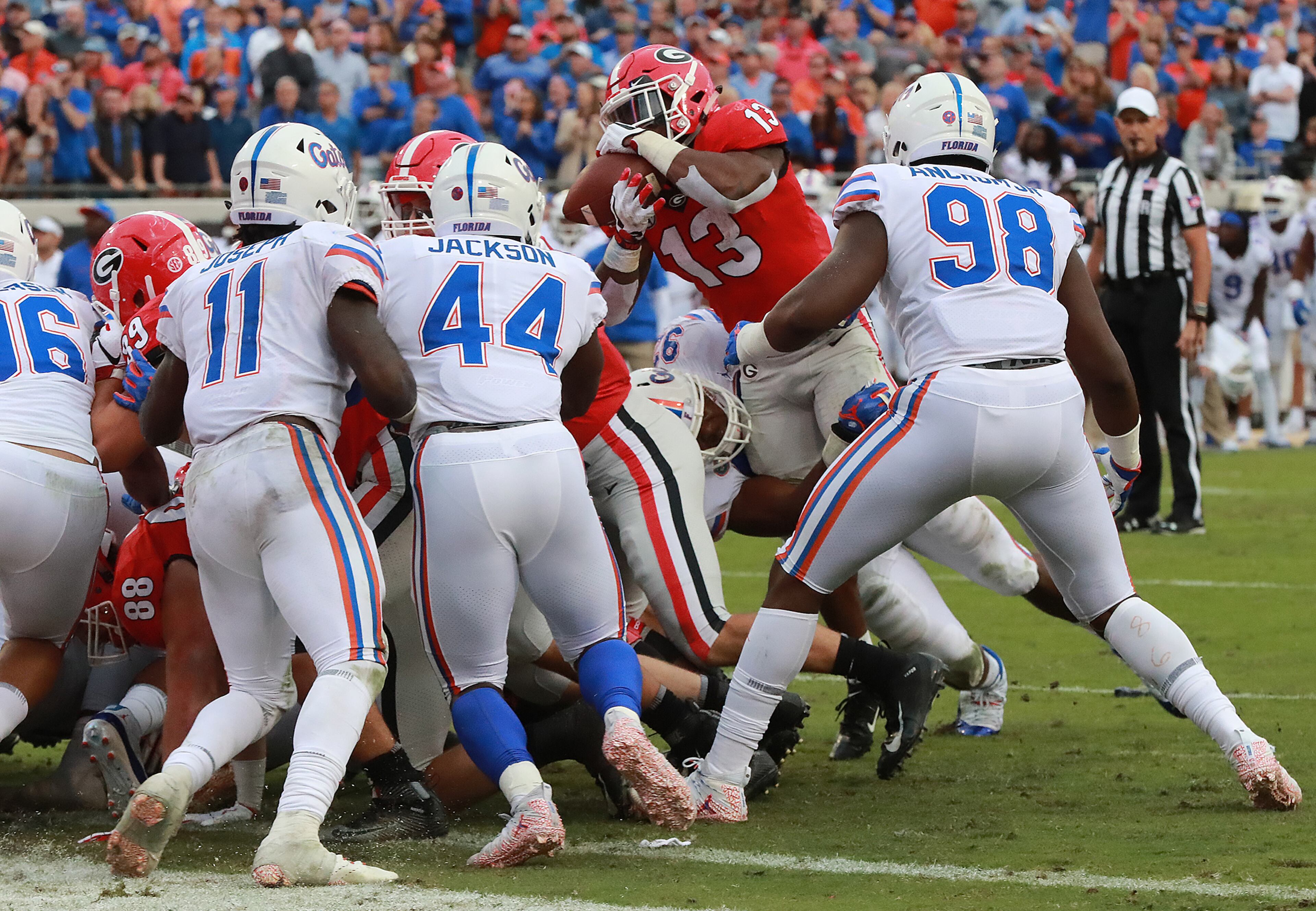 October 27, 2018 Jacksonville: Florida defenders stop Georgia tailback Elijah Holyfield on a 3rd and 1 attempt at the goalline forcing a fieldgoal after Georgia recovered a Florida fumble on the 1-yard line during the 3rd quarter in the Georgia-Florida NCAA college football game on Saturday, Oct 27, 2018, in Jacksonville. Curtis Compton/ccompton@ajc.com