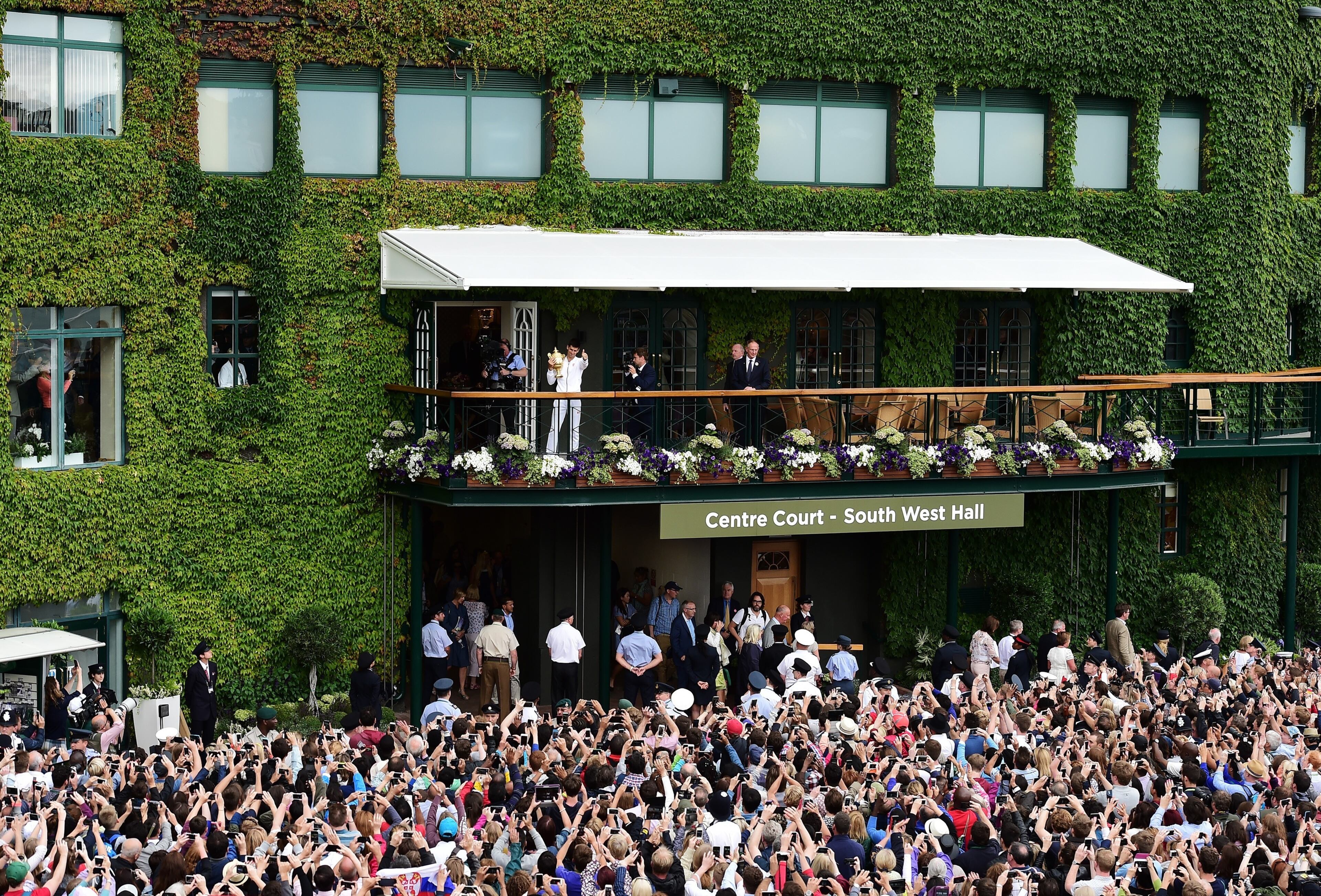LONDON, ENGLAND - JULY 12: Novak Djokovic celebrates with the trophy after victory over Roger Federer of Switzerland in the Gentleman's Singles Final during day thirteen of the Wimbledon Lawn Tennis Championships at the All England Lawn Tennis and Croquet Club on July 12, 2015 in London, England. (Photo by Alex Broadway/Anadolu Agency/Getty Images)