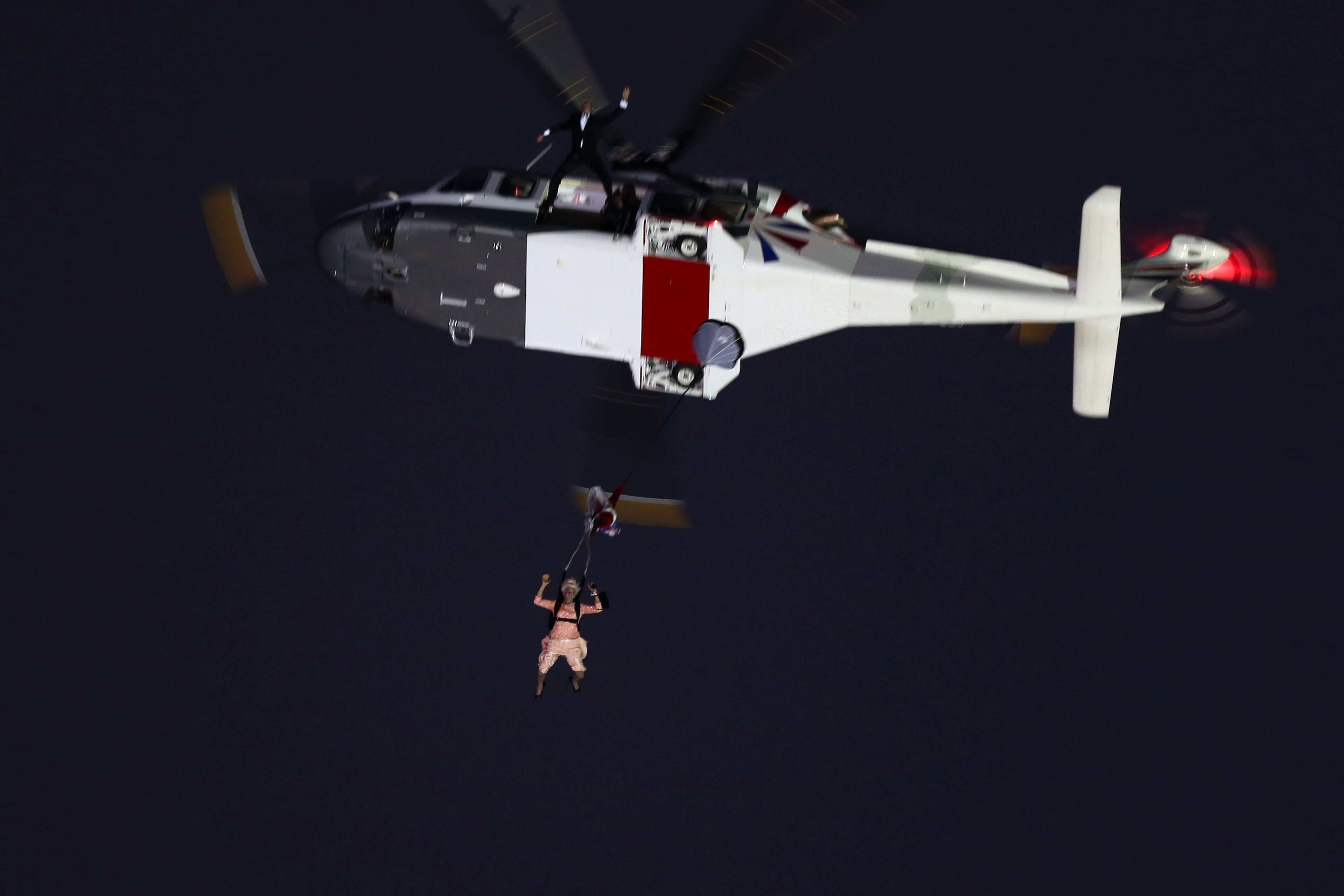 A person dressed as Queen Elizabeth II parachutes into the Olympic stadium during the Opening Ceremony of the London 2012 Olympic Games at the Olympic Stadium on July 27, 2012 in London, England. (Photo by Ezra Shaw/Getty Images)
