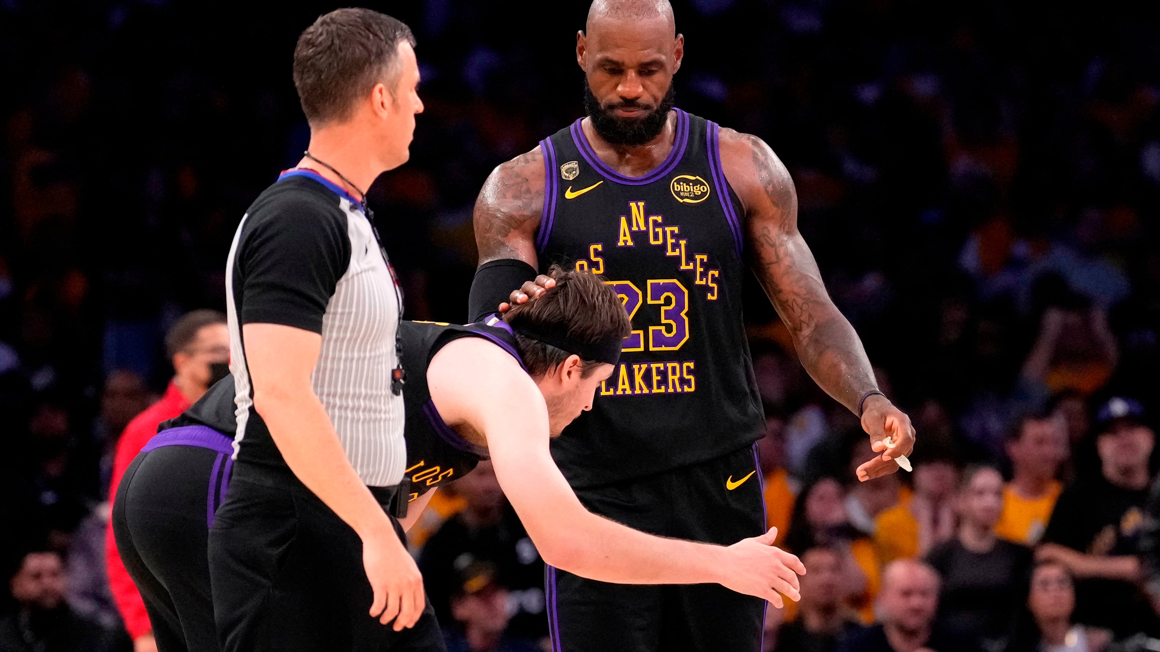 Los Angeles Lakers forward LeBron James, right, pats guard Austin Reaves on the head after Reaves missed a three-point shot with 11 seconds left in Game 4 of a second-round NBA basketball playoffs series against the Oklahoma City Thunder, Monday, May 11, 2026, in Los Angeles. (AP Photo/Mark J. Terrill)