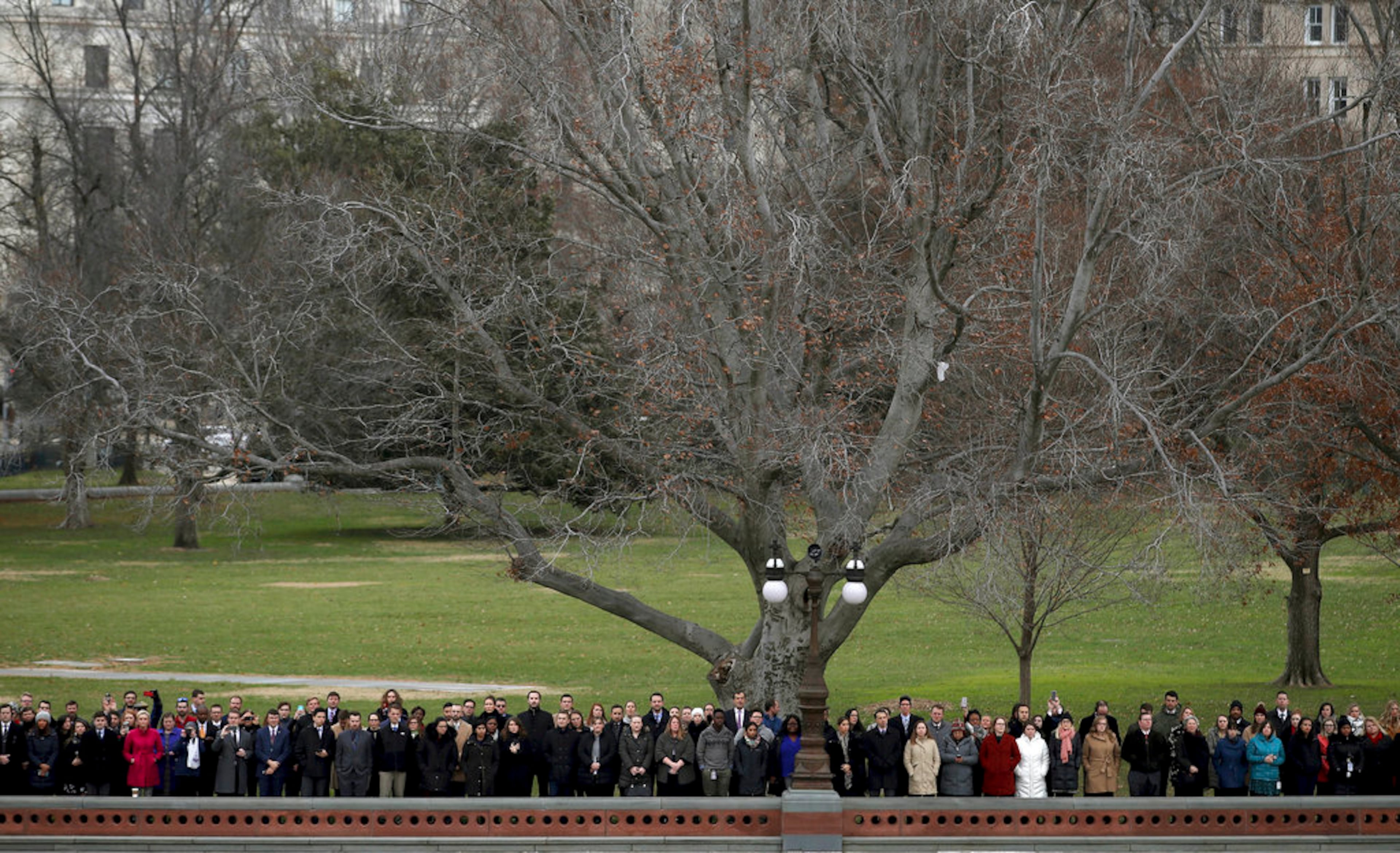 Spectators watch as a joint services military honor guard carries the flag-draped casket of former President George H.W. Bush from the U.S. Capitol Wednesday, Dec. 5, 2018, in Washington. (Win McNamee/Pool Photo via AP)