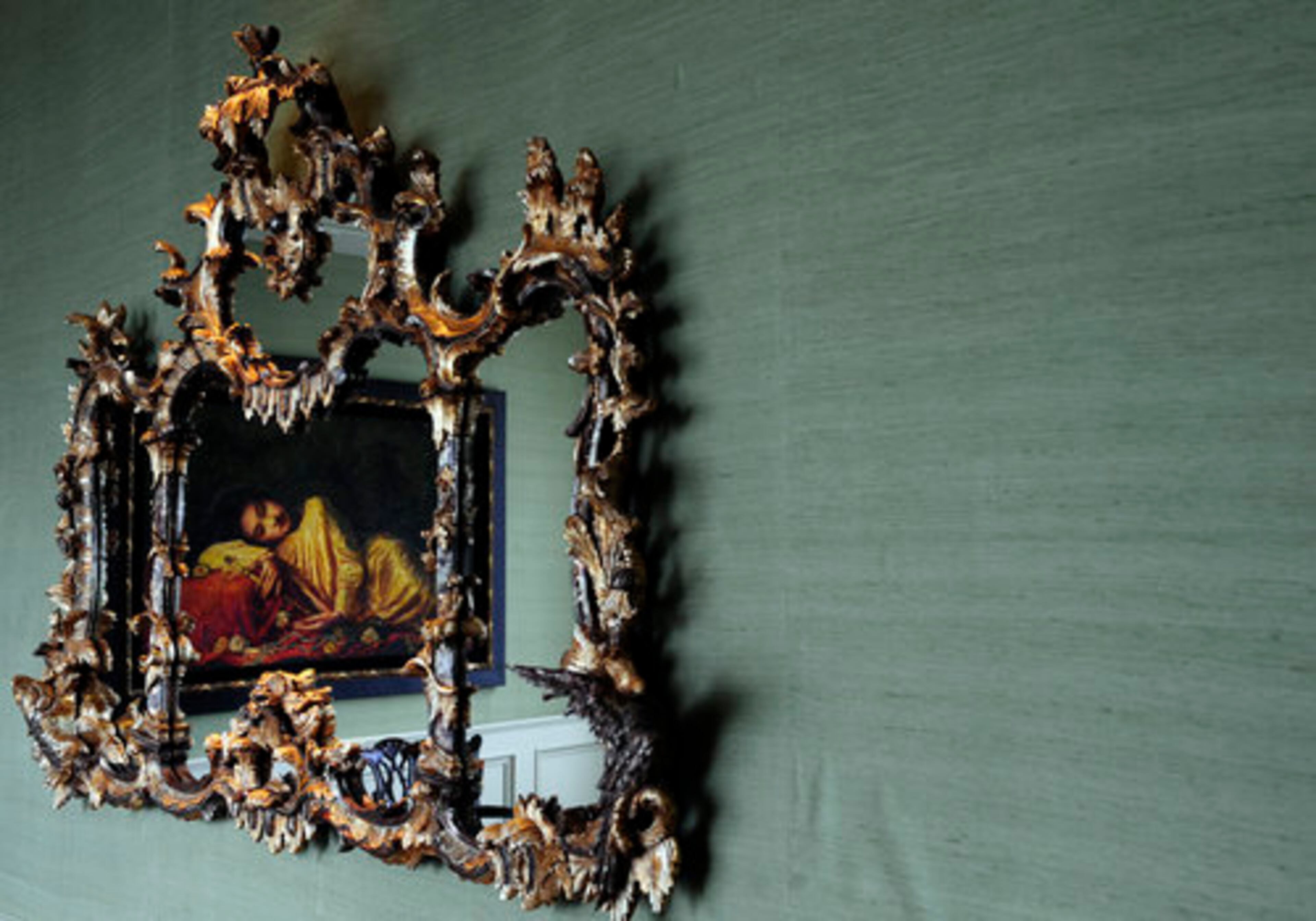 The languid painting at the head of the dining table is reflected in the ornate gilt mirror Terwilliger brought to Atlanta from his New York residence.
