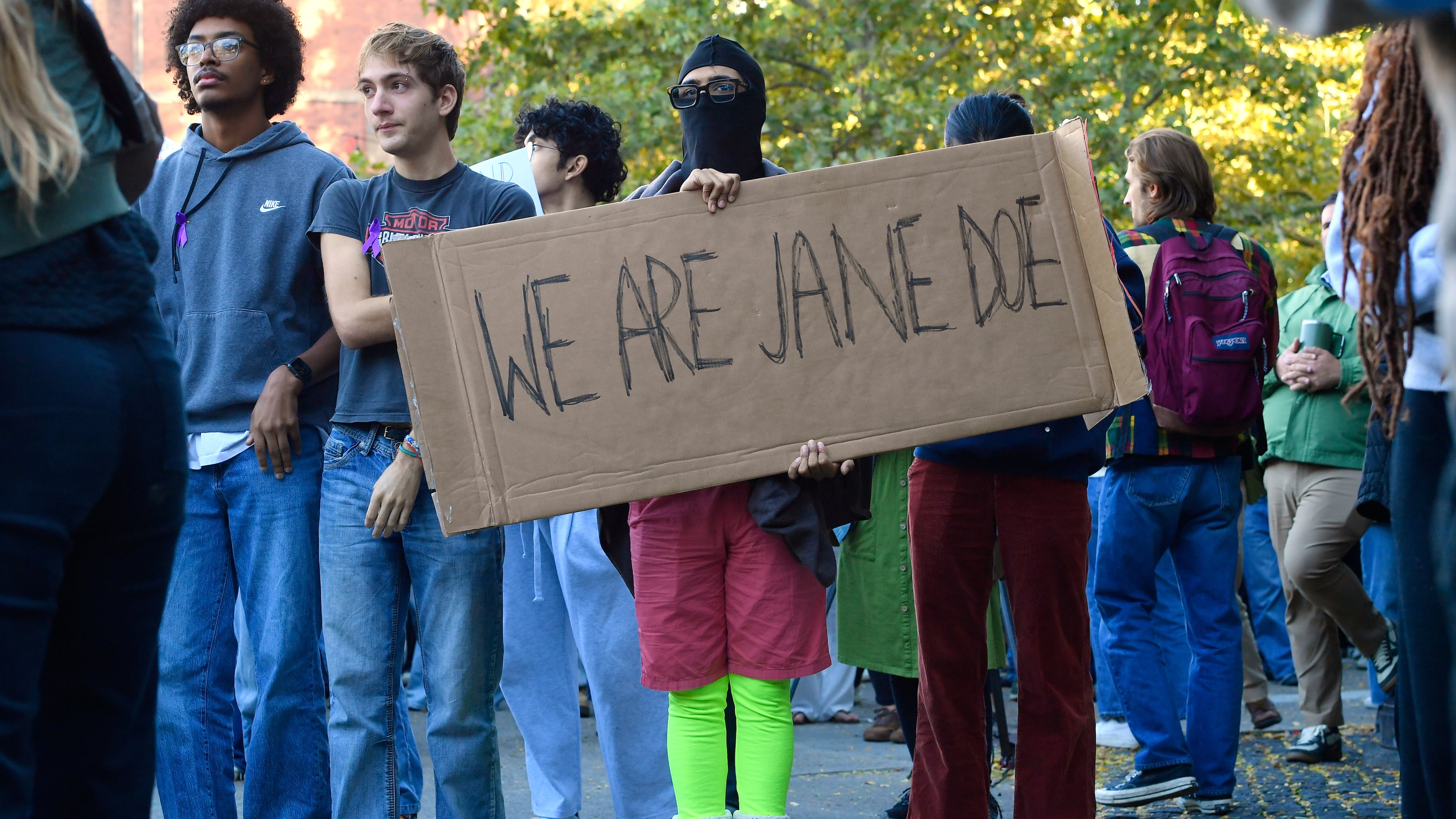 A demonstrator holds a sign reading "We Are Jane Doe" during a protest against Cornell University's handling of the 2024 fraternity-house gang rape allegations at the campus, Monday, Oct. 5, 2026, in Ithaca, N.Y. (Adrian Kraus/AP)