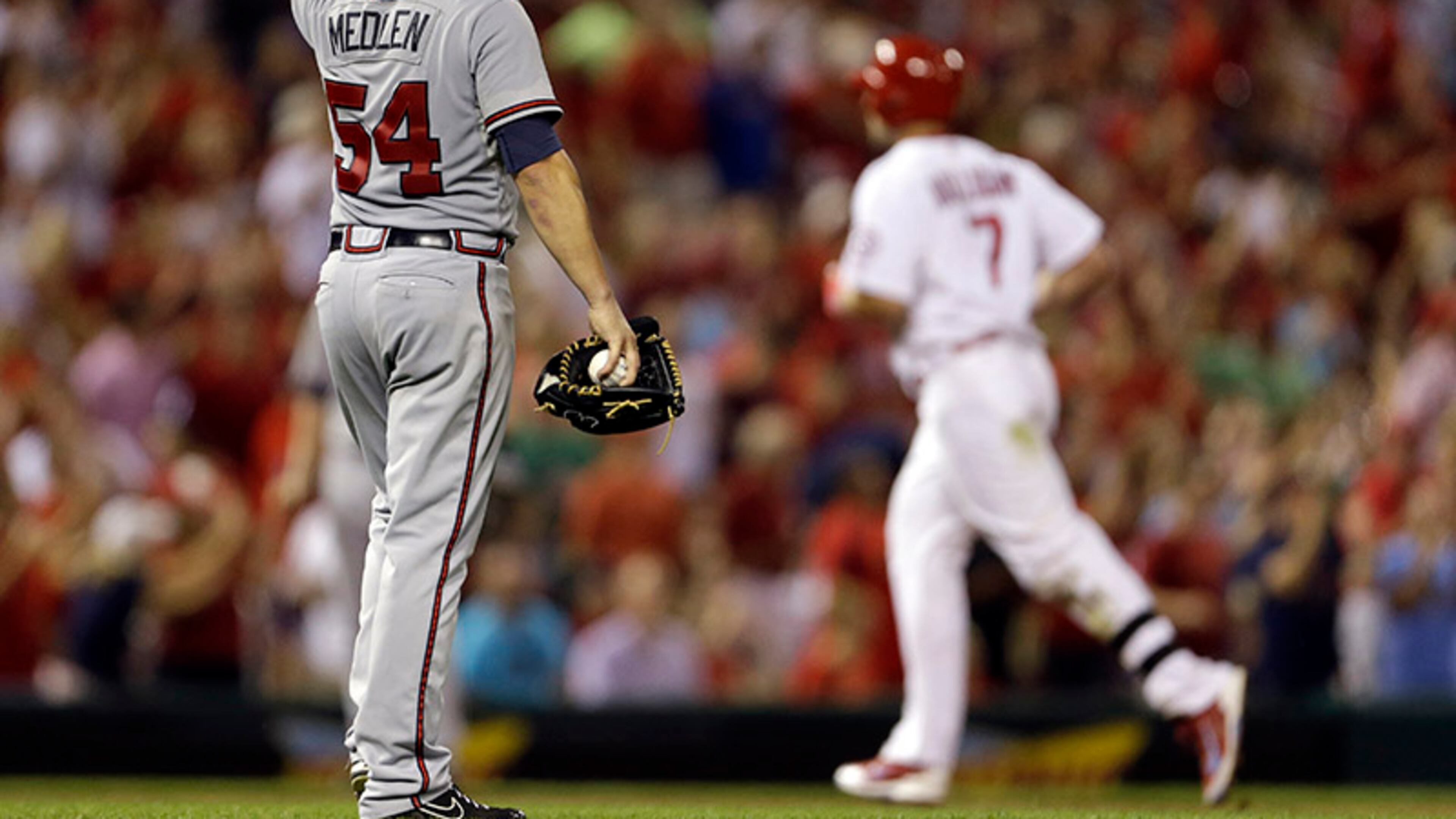 St. Louis Cardinals' Matt Holliday (background) rounds the bases after hitting a solo home run off Atlanta Braves starting pitcher Kris Medlen in the sixth inning of a 3-1 Braves loss Friday in St. Louis.