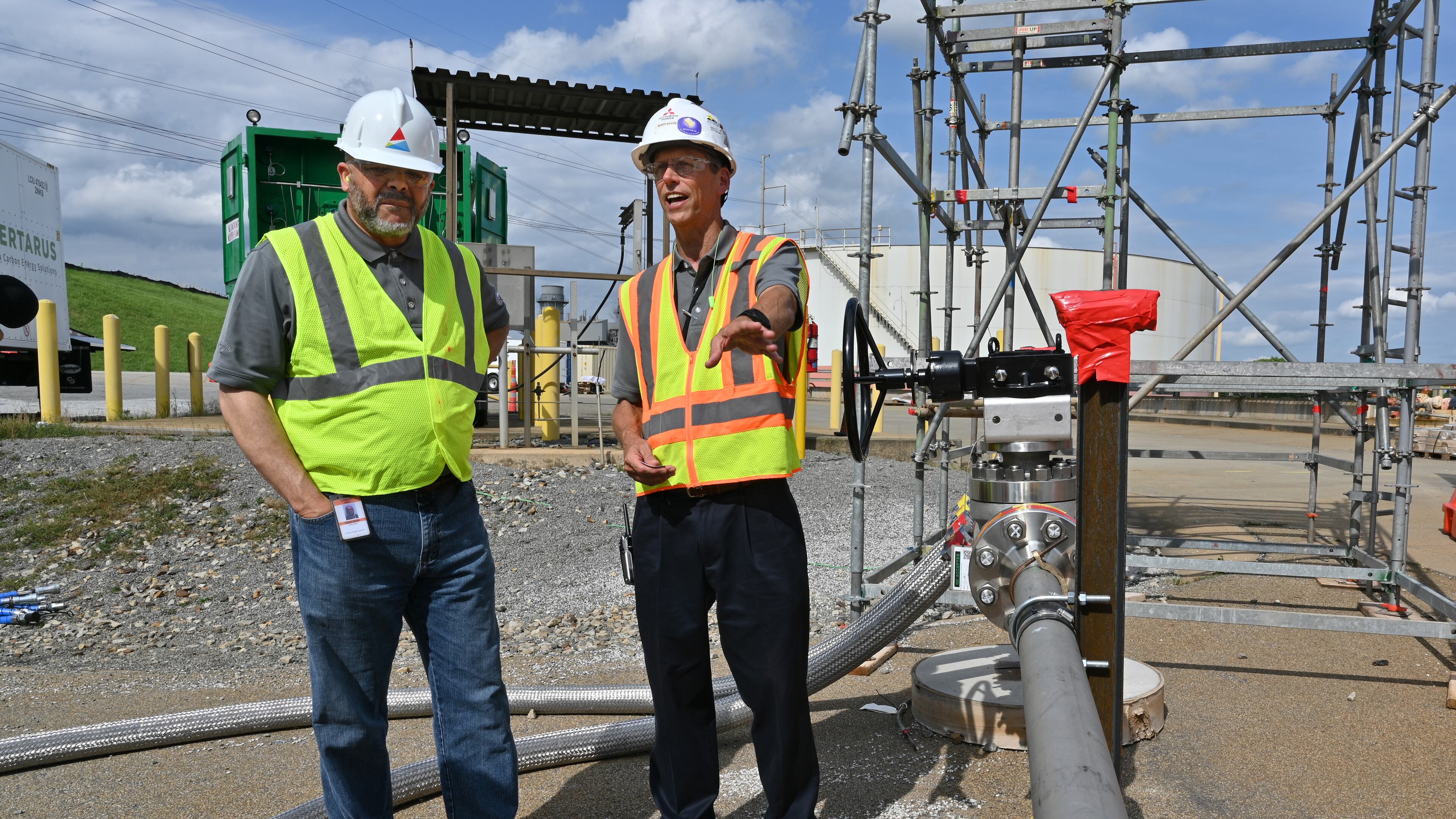 June 8, 2022 Smyrna - Dr. Mark Berry (left), vice president of Environmental and Natural Resources, and Scott Cloyd, Chief Engineer at Mitsubishi Power Americas, talk at Georgia Power’s Plant McDonough-Atkinson, on Wednesday, June 8, 2022. Georgia Power is conducting a test where it will burn hydrogen using existing infrastructure at plant McDonough. (Hyosub Shin / Hyosub.Shin@ajc.com)