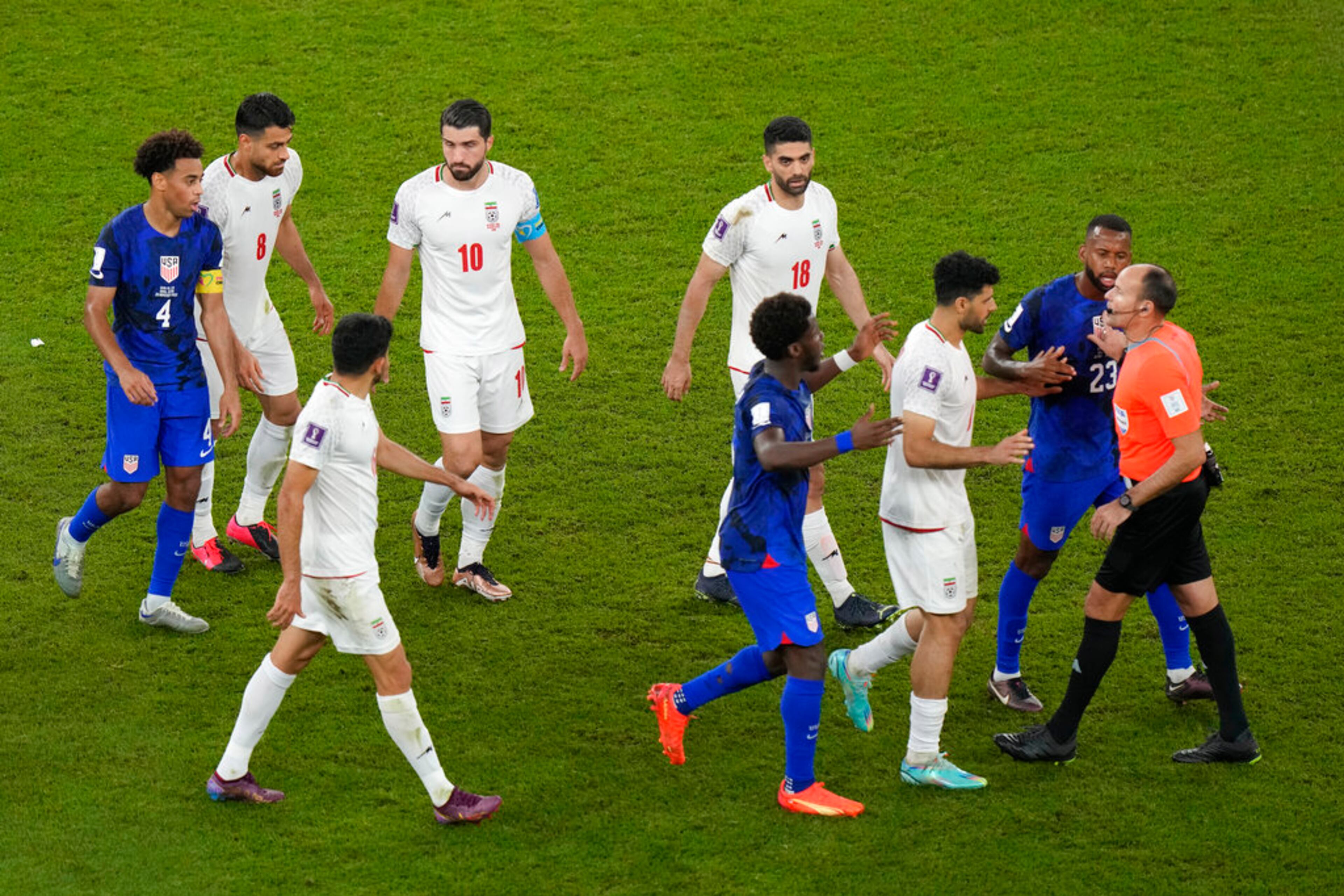 Iran players talks to referee Antonio Mateu, of Spain, during the World Cup group B soccer match between Iran and the United States at the Al Thumama Stadium in Doha, Qatar, Wednesday, Nov. 30, 2022. (AP Photo/Luca Bruno)