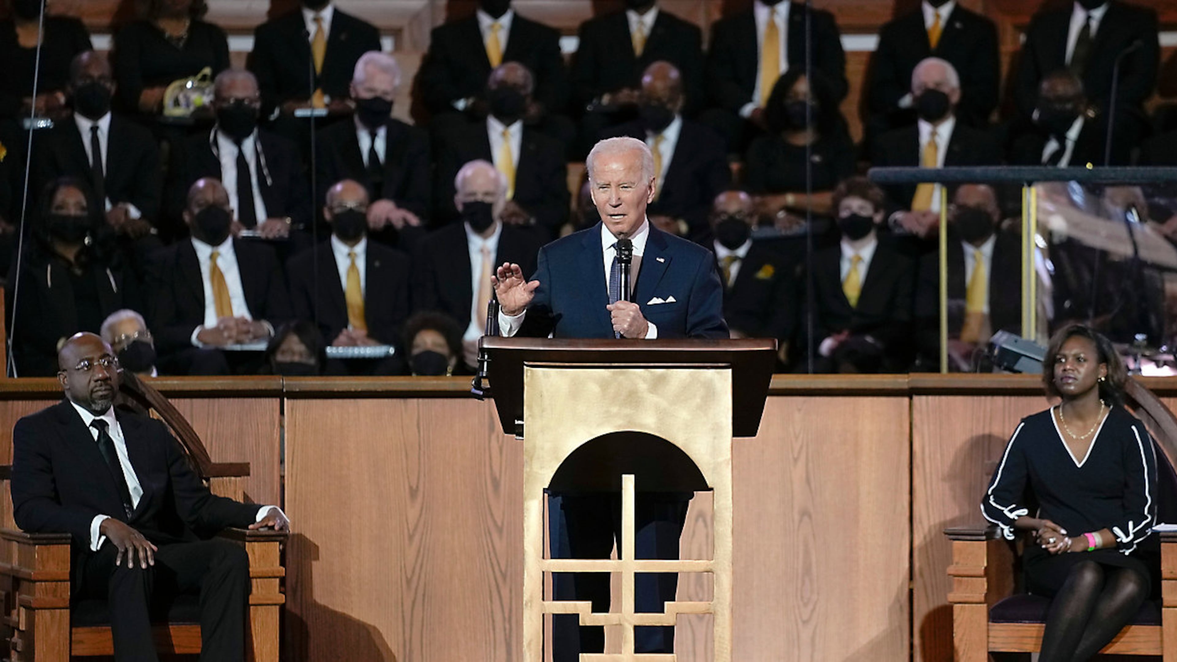 President Joe Biden speaks at Ebenezer Baptist Church in Atlanta, Sunday, Jan. 15, 2023, during a service honoring Martin Luther King Jr. Sen. Raphael Warnock, D-Ga., a senior pastor at Ebenezer Baptist Church, listens at left. (Carolyn Kaster/AP 2023)