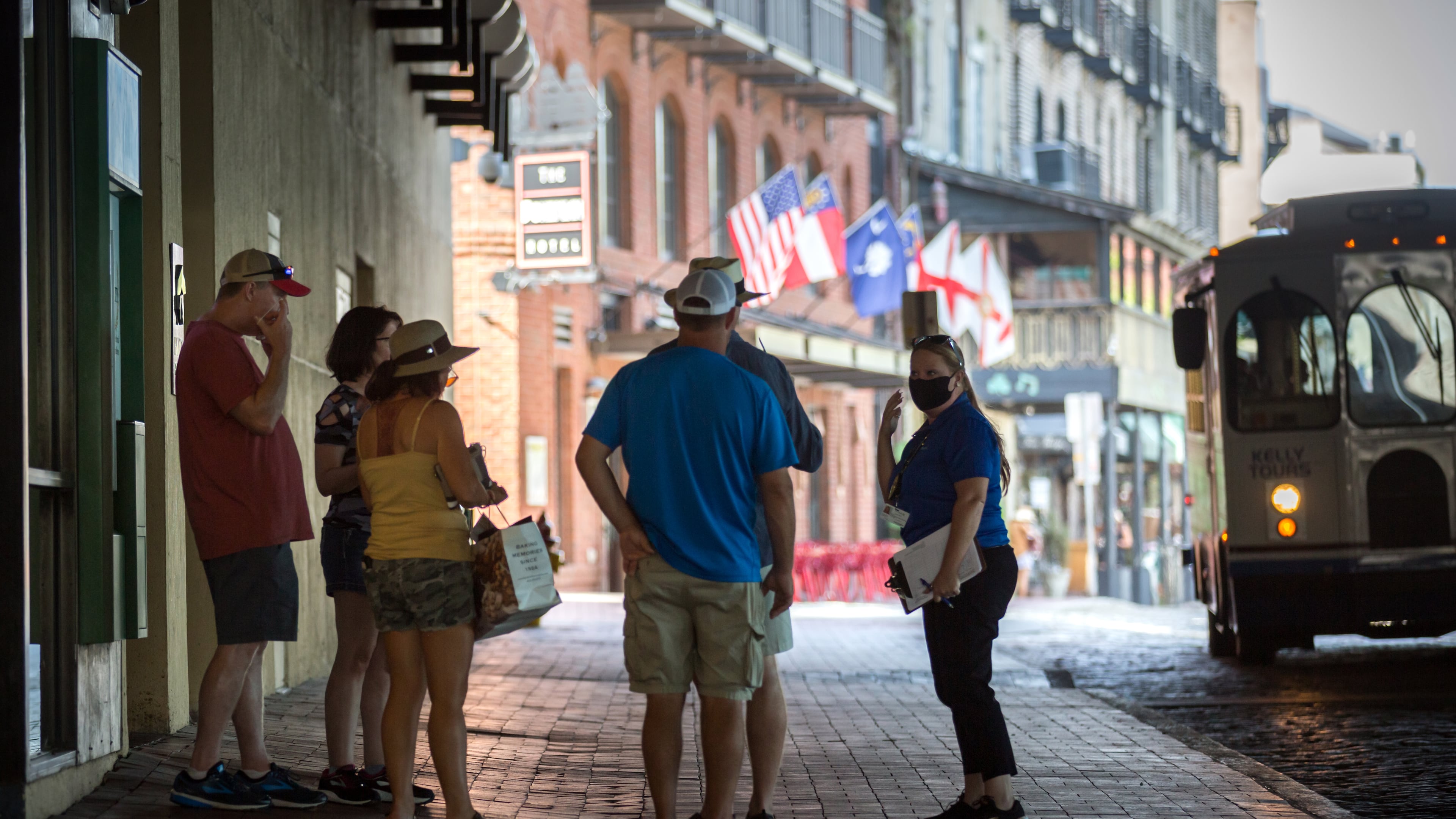 SAVANNAH, GA - Sept. 4, 2020: CoVid Resource Team member Nicole Bush, right, reminds a group of people to wear masks while visiting River Street in historic downtown Savannah. (AJC Photo/Stephen B. Morton)