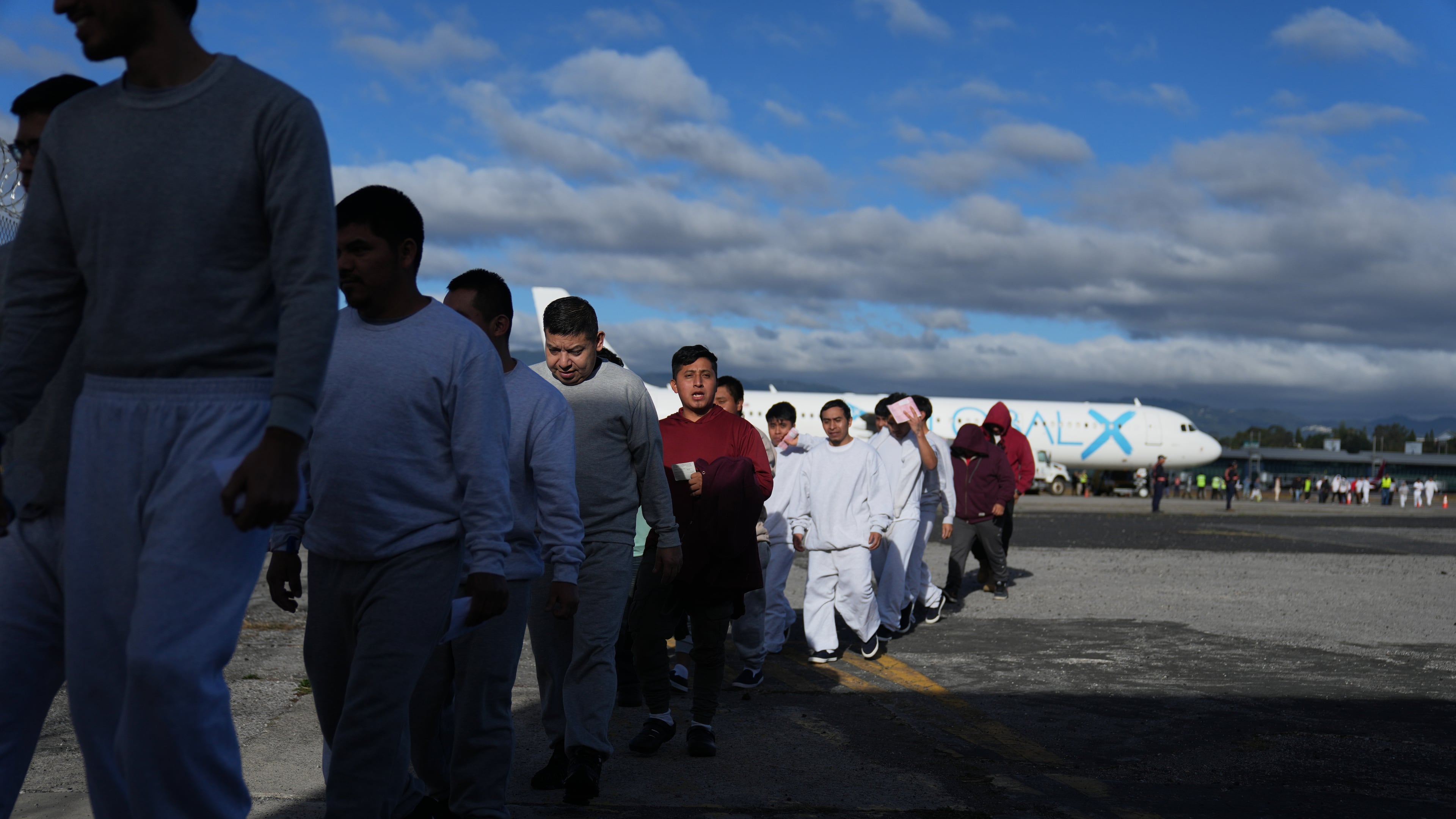 FILE - Guatemalans deported from the U.S. arrive at La Aurora airport in Guatemala City, Dec. 30, 2025, after deplaning a repatriation flight. (AP Photo/Moises Castillo, File)